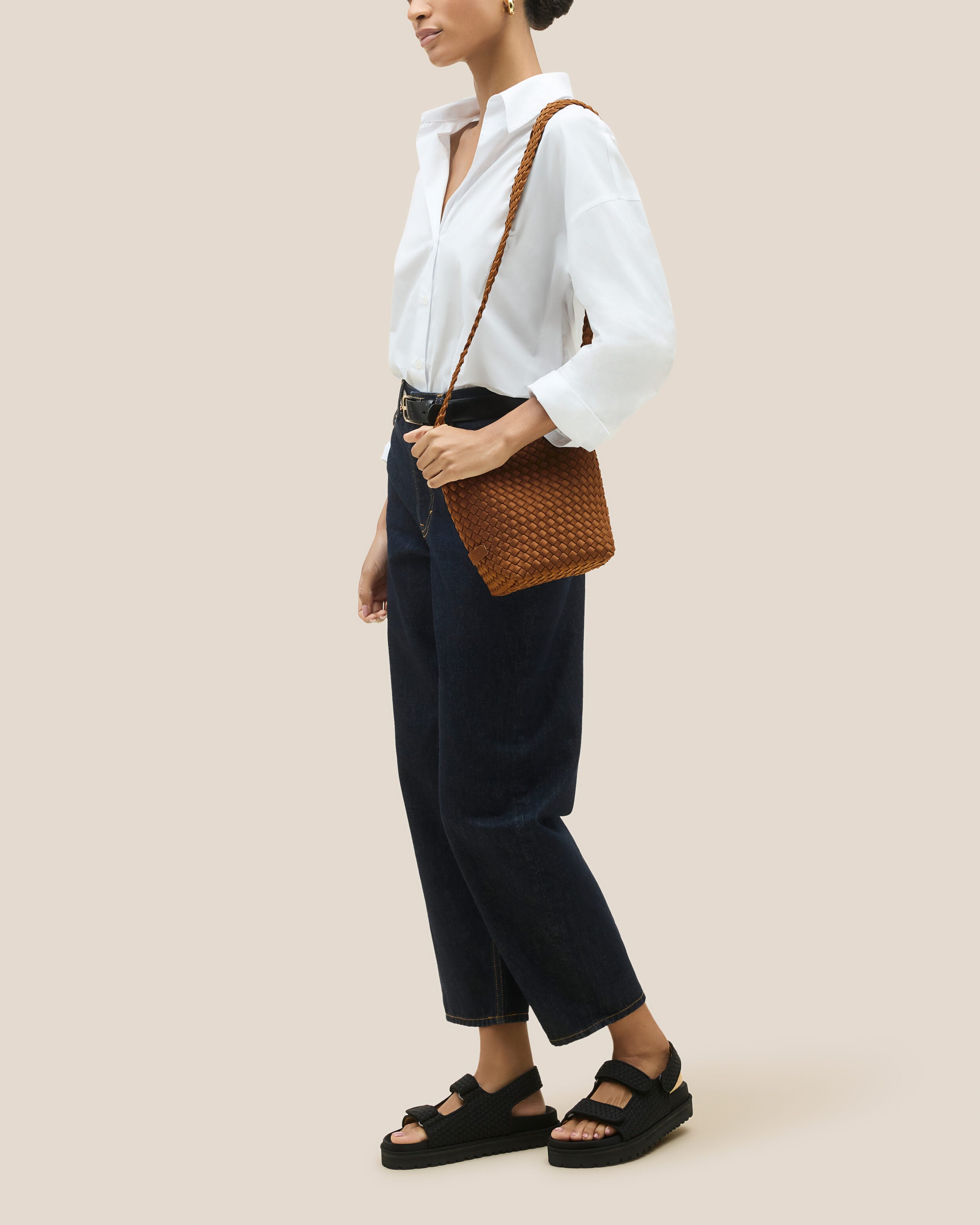 Laguna Crossbody in Teak shown on model to illustrate scale and soft silhouette.