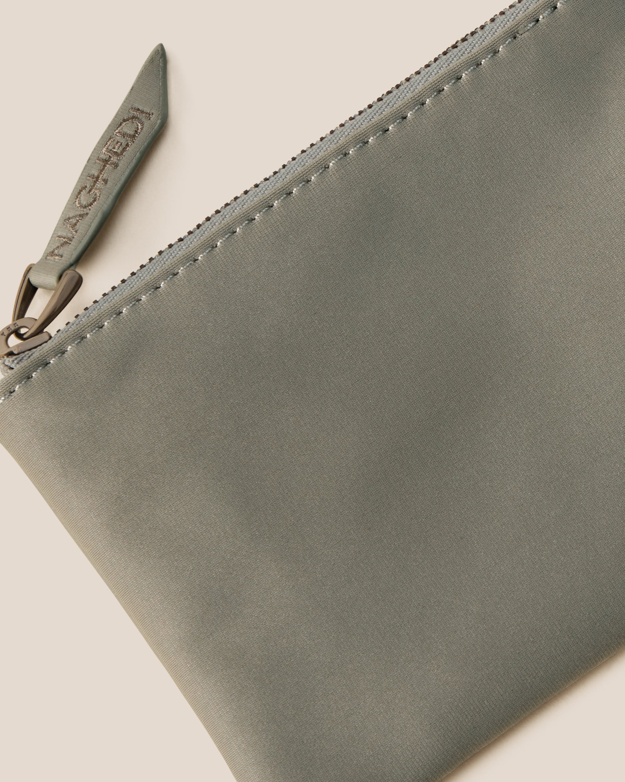 Close-up of included coordinating neoprene zippered pouch.