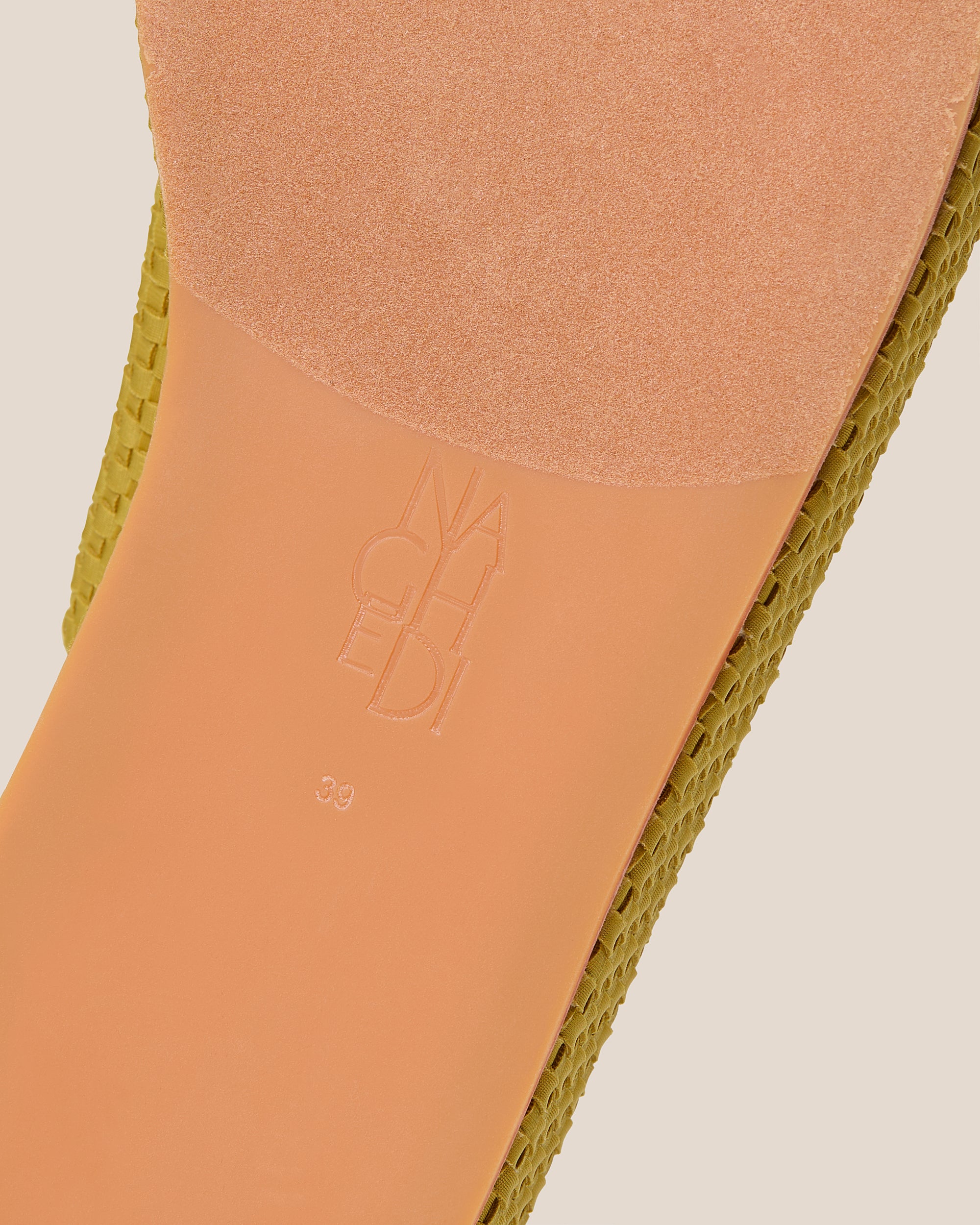 Shoe sole showing natural rubber sole, stamped NAGHEDI logo and size detail for Laguna Platform Sandal in Chartreuse.