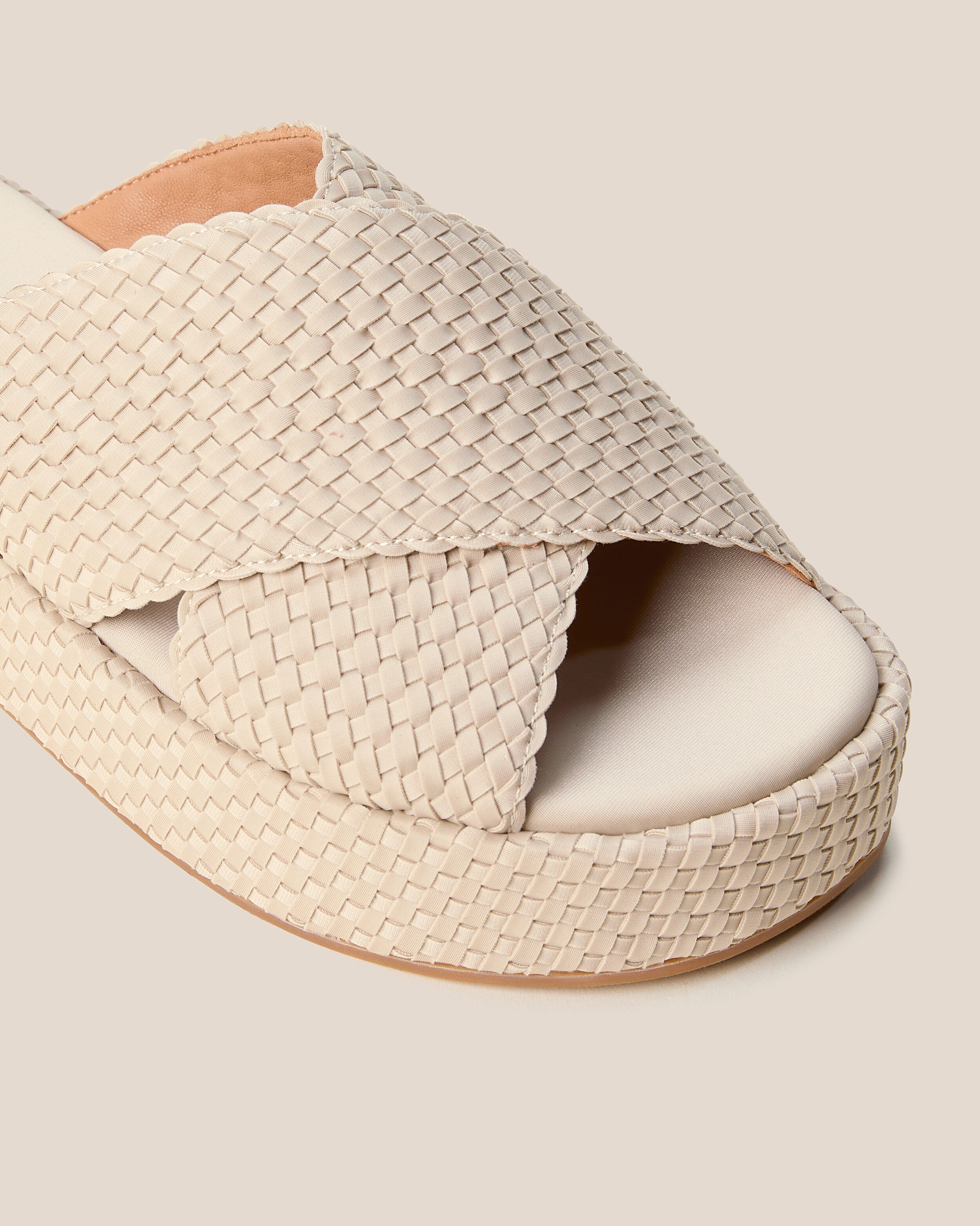 Close-up of The Laguna Platform in Ecru showing its open toe and round silhouette.
