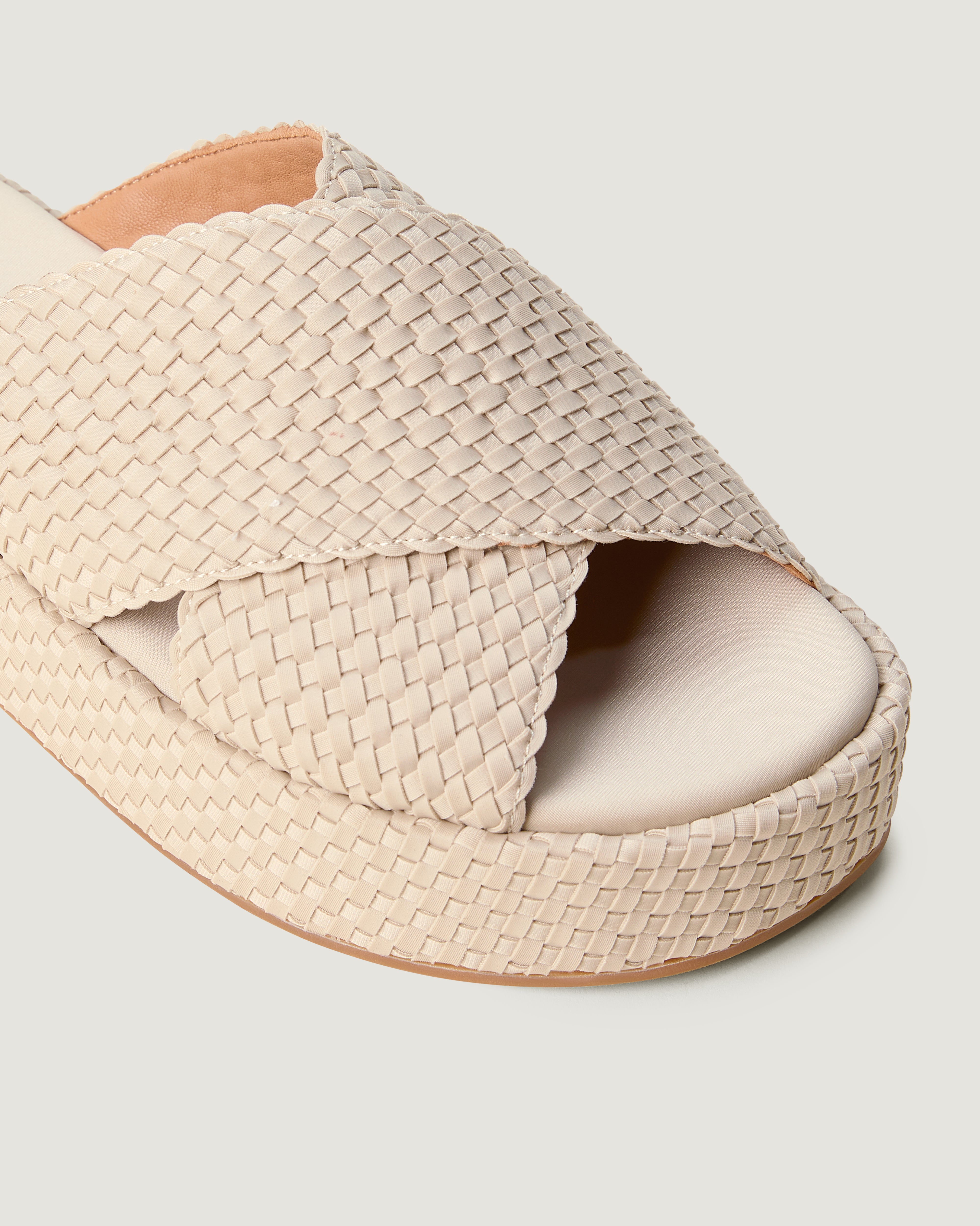 Close-up of The Laguna Platform in Ecru showing its open toe and round silhouette.