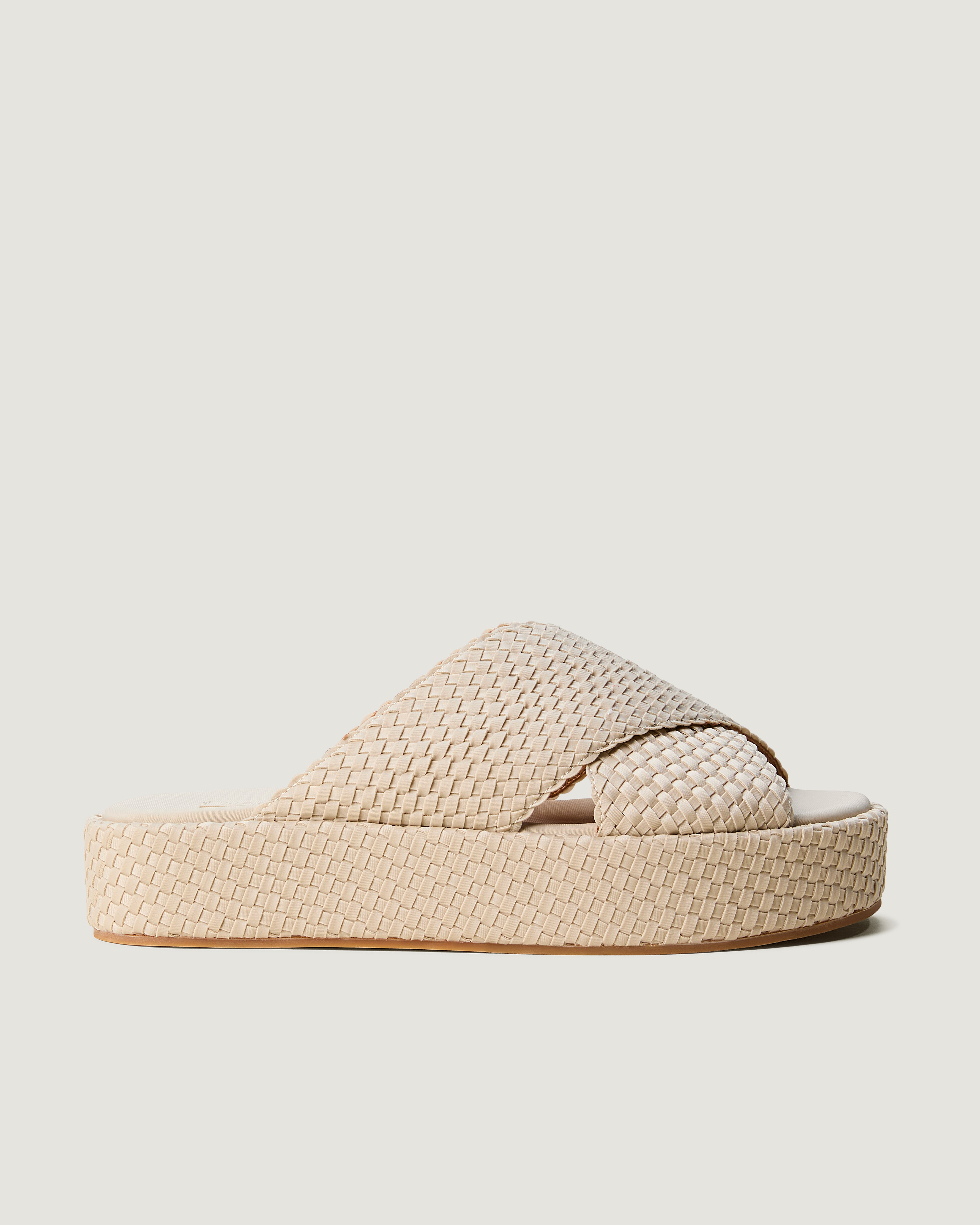 Side view of The Laguna Platform in Ecru, a cream tone, featuring an open toe and round silhouette.