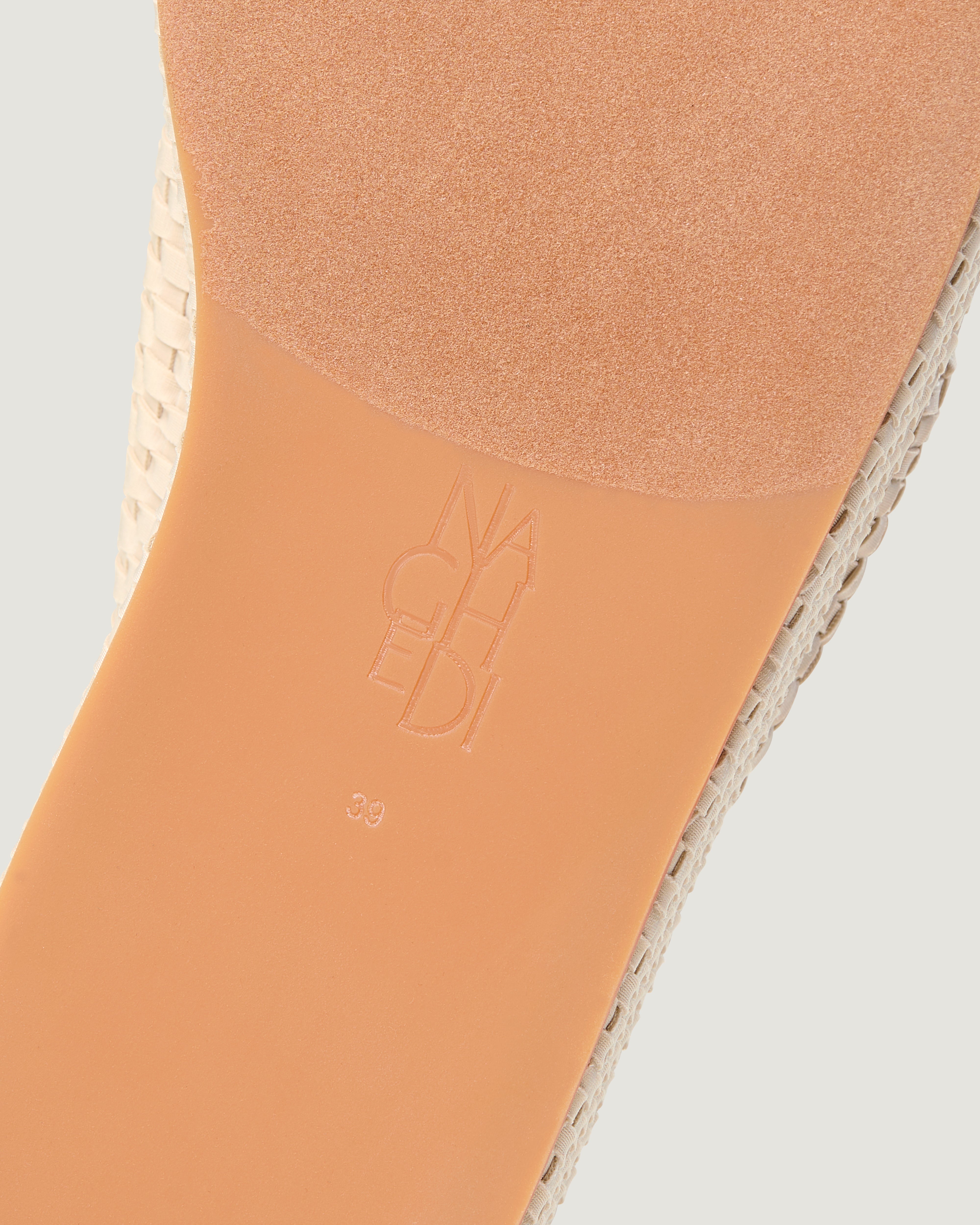 Shoe sole showing natural rubber sole, stamped NAGHEDI logo and size detail for The Laguna Platform in Ecru.