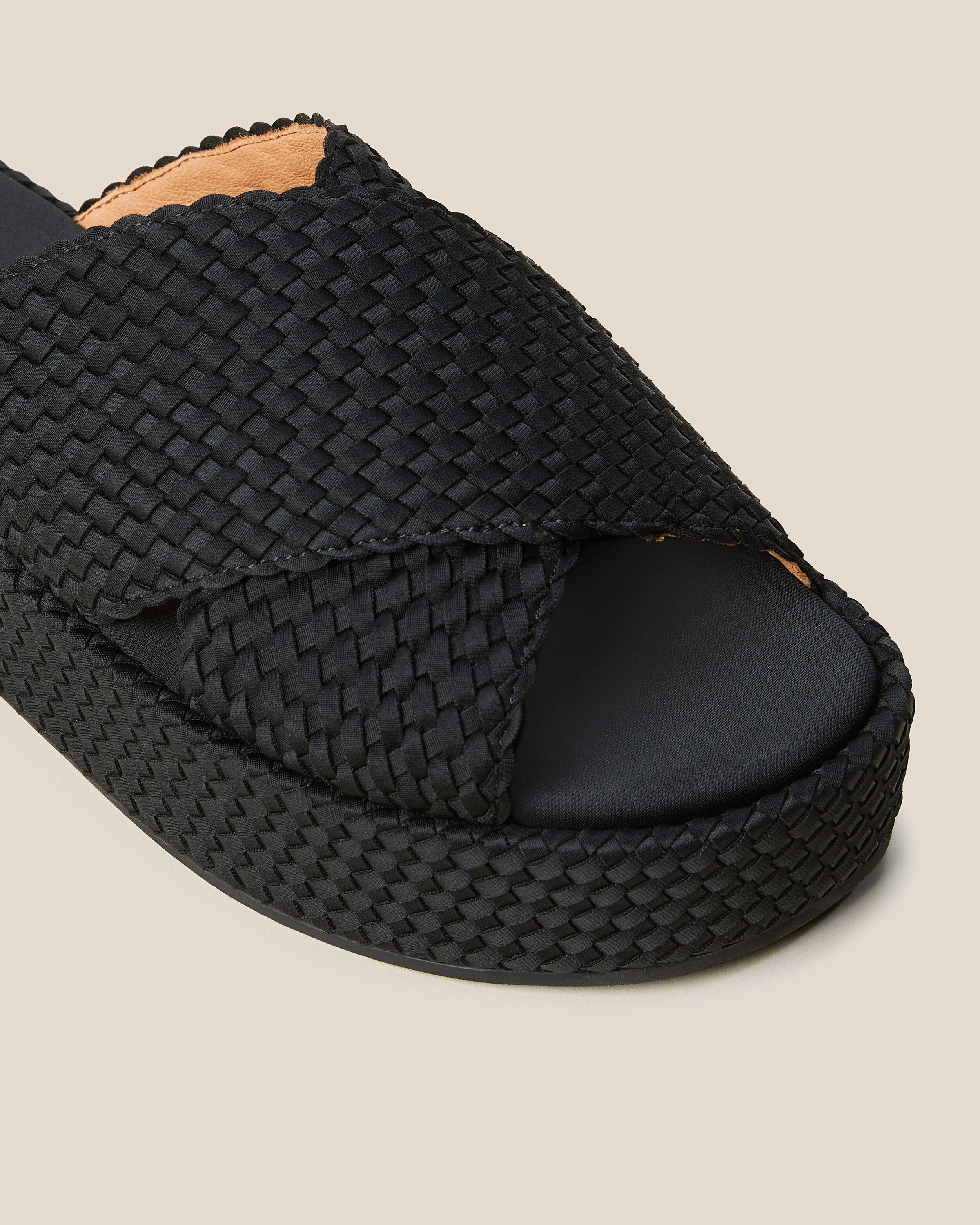 Close-up of The Laguna Platform in Onyx showing its open toe and round silhouette.