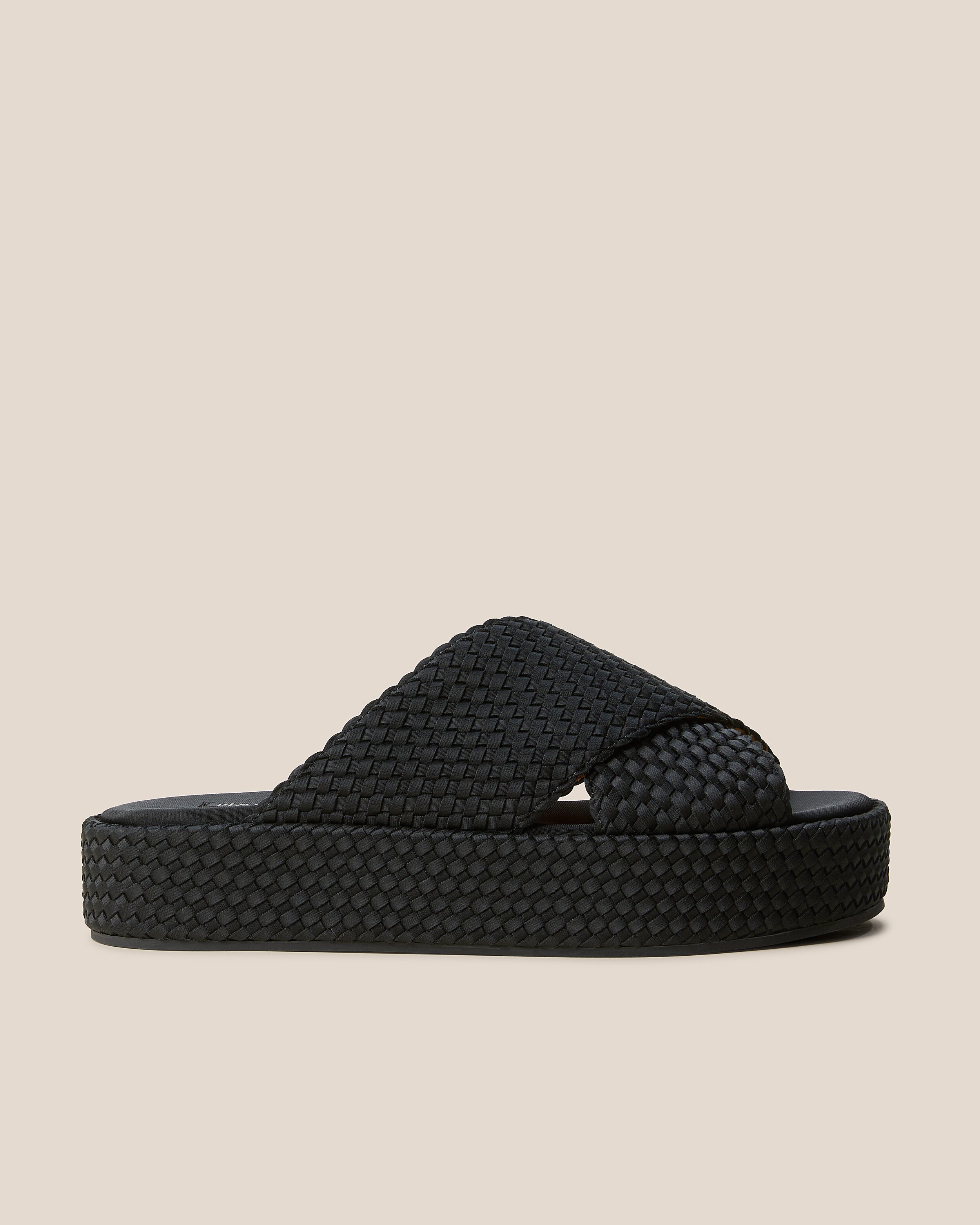 Side view of The Laguna Platform in Onyx, a true black tone, featuring an open toe and round silhouette.