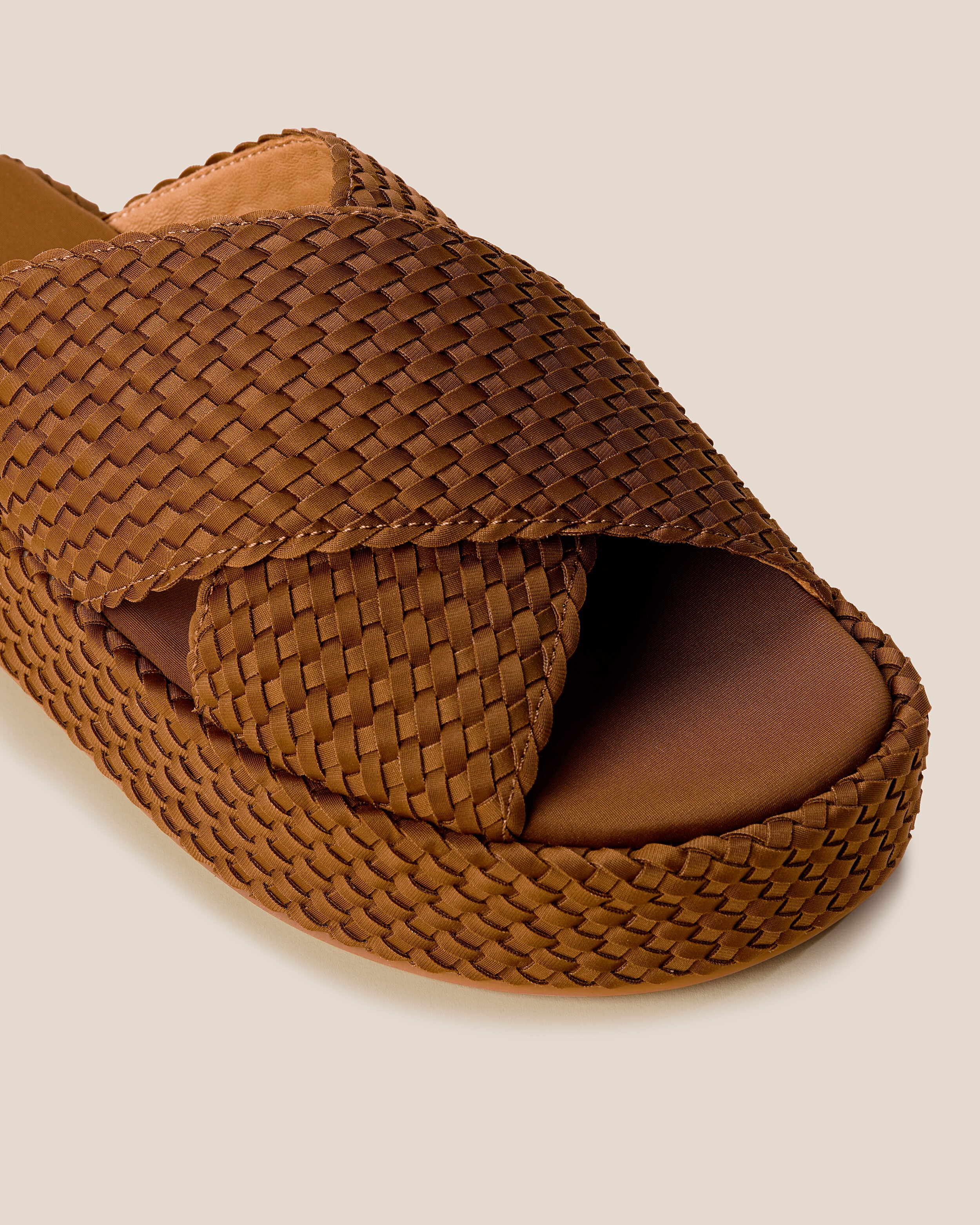 Close-up of The Laguna Platform in Teak showing its open toe and round silhouette.