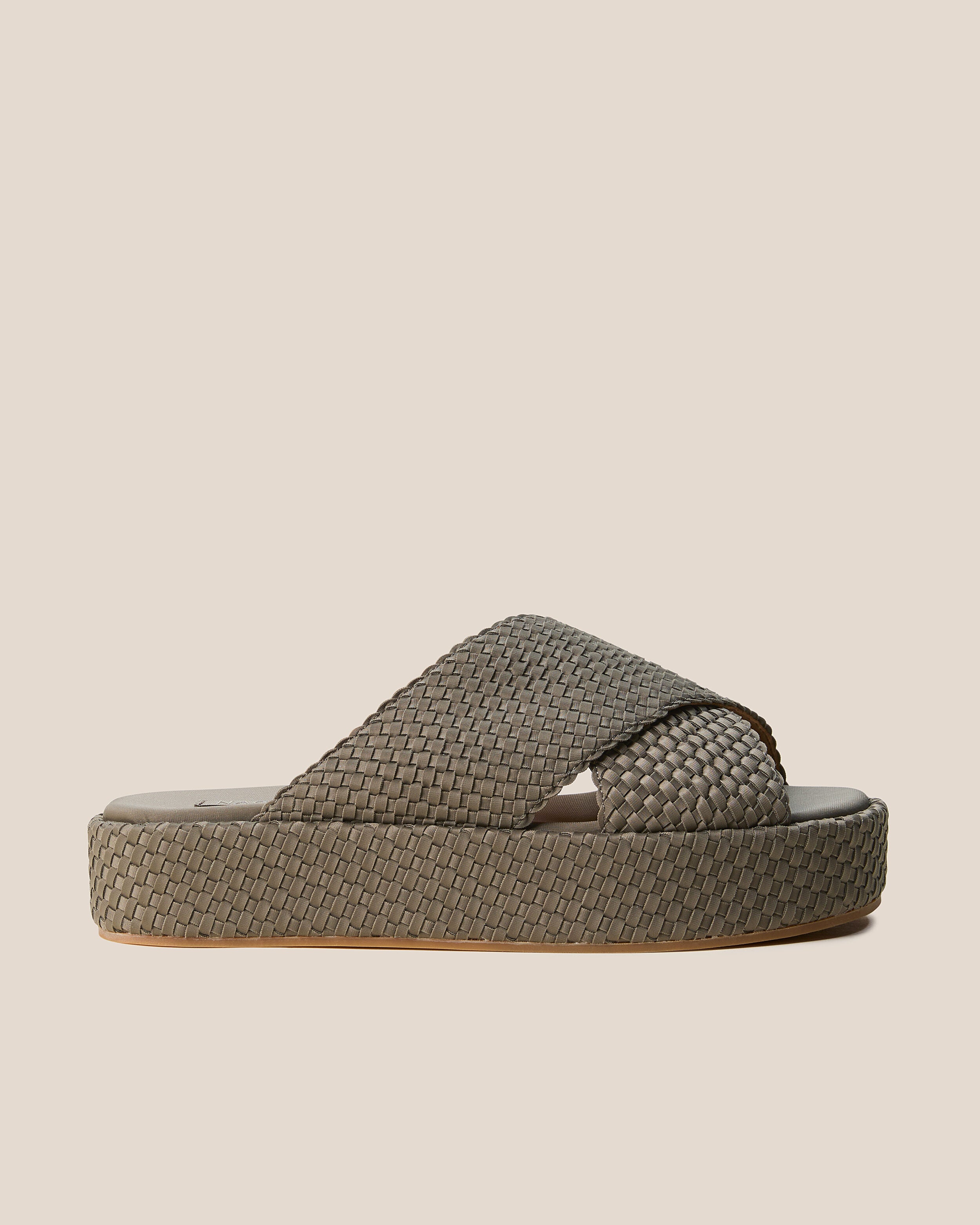 Side view of The Laguna Platform in Terre, a muted earth brown tone, featuring an open toe and round silhouette.