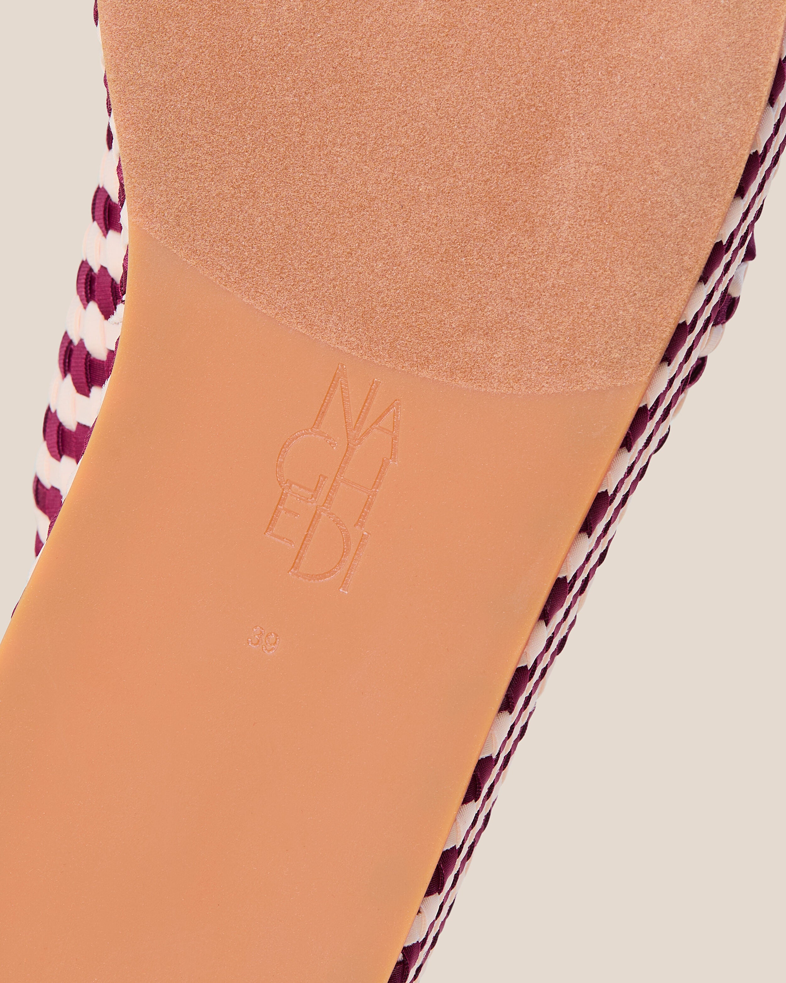 Shoe sole showing natural rubber sole, stamped NAGHEDI logo and size detail for The Laguna Platform in Jaipur.