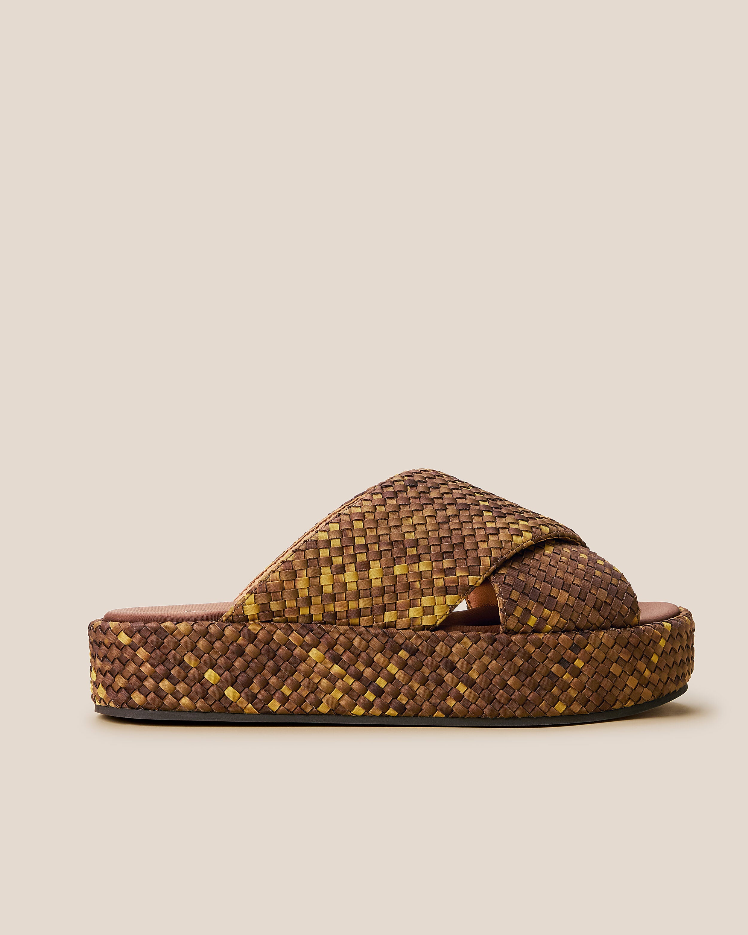 Side view of The Laguna Platform in Tortoiseshell, a mustard gold and dark chocolate brown tone, featuring an open toe and round silhouette.