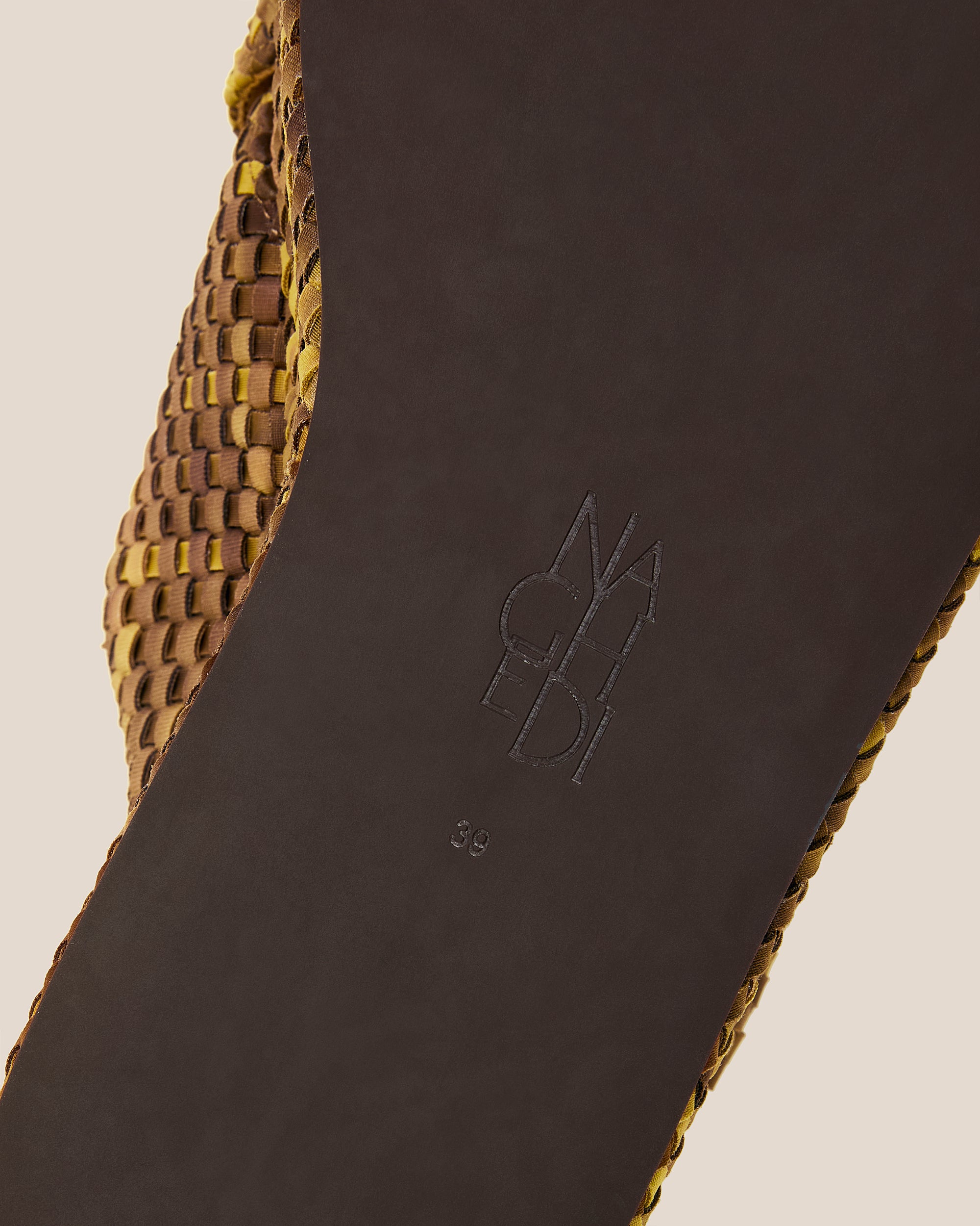 Shoe sole showing natural rubber sole, stamped NAGHEDI logo and size detail for Laguna Watercolor Platform Sandal in Tortoiseshell.