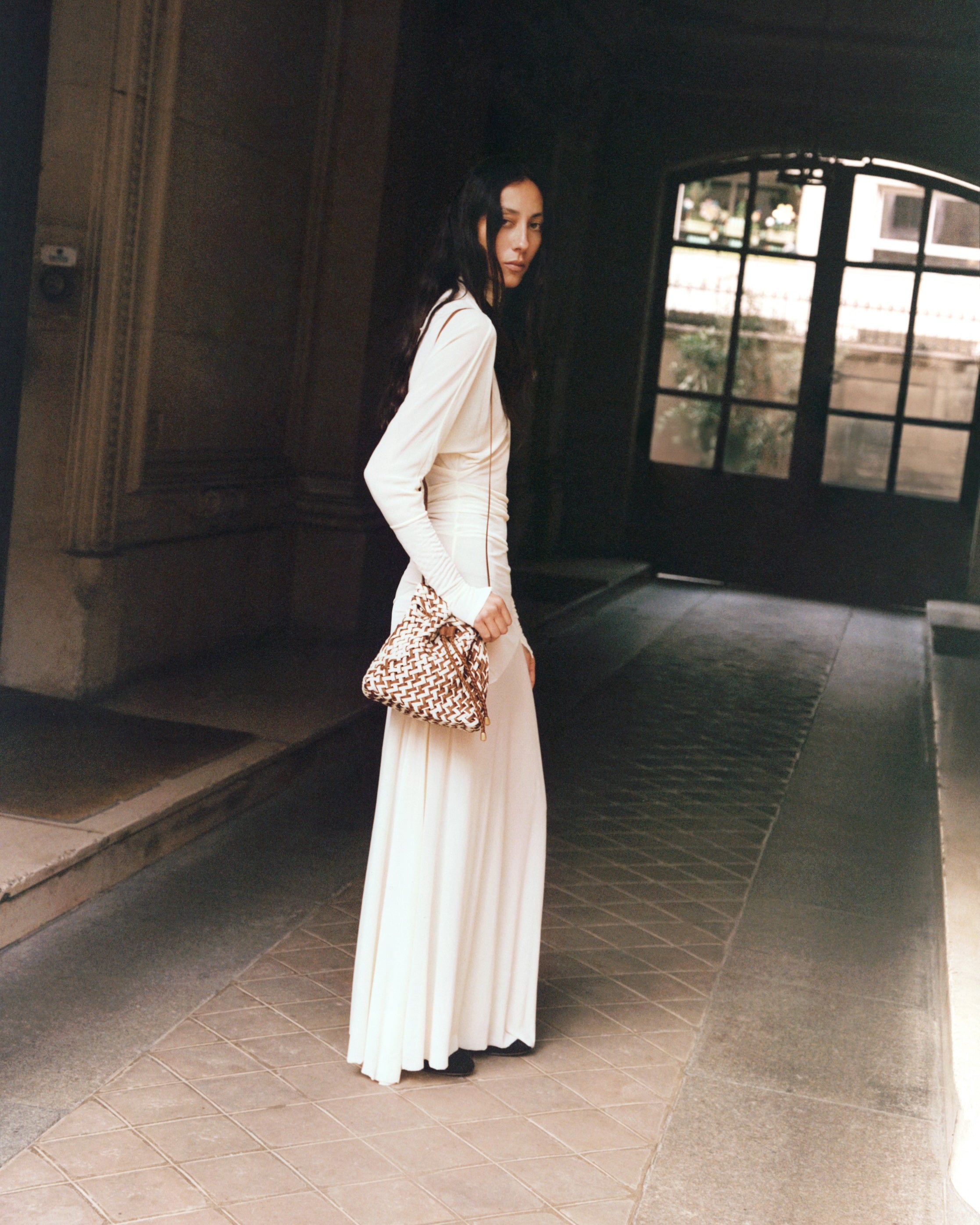 Gramercy Bucket in Carmel shown on model to illustrate scale and soft silhouette.