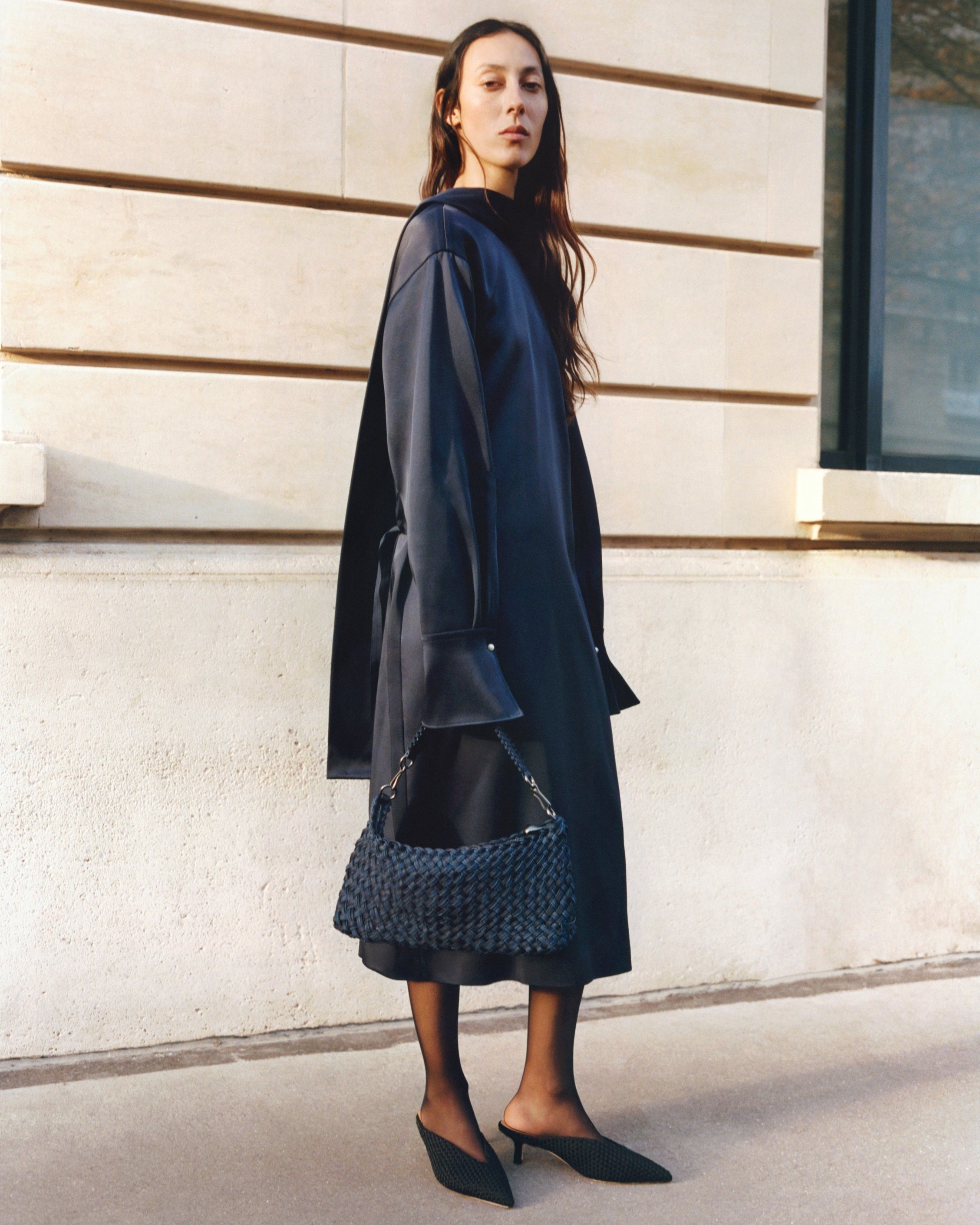 On model image of Porto Half-Moon in Indigo showing its hand stitched strap and custom brushed gunmetal hardware.