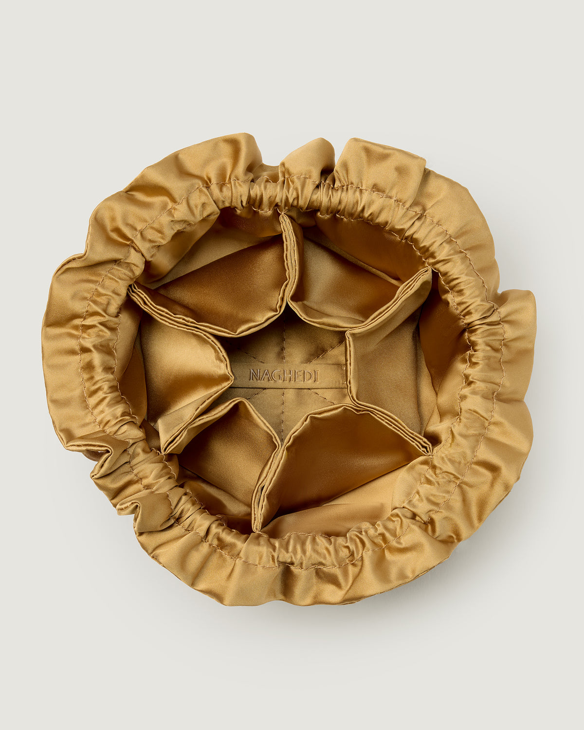 Inside view of a small gold satin drawstring jewelry pouch.