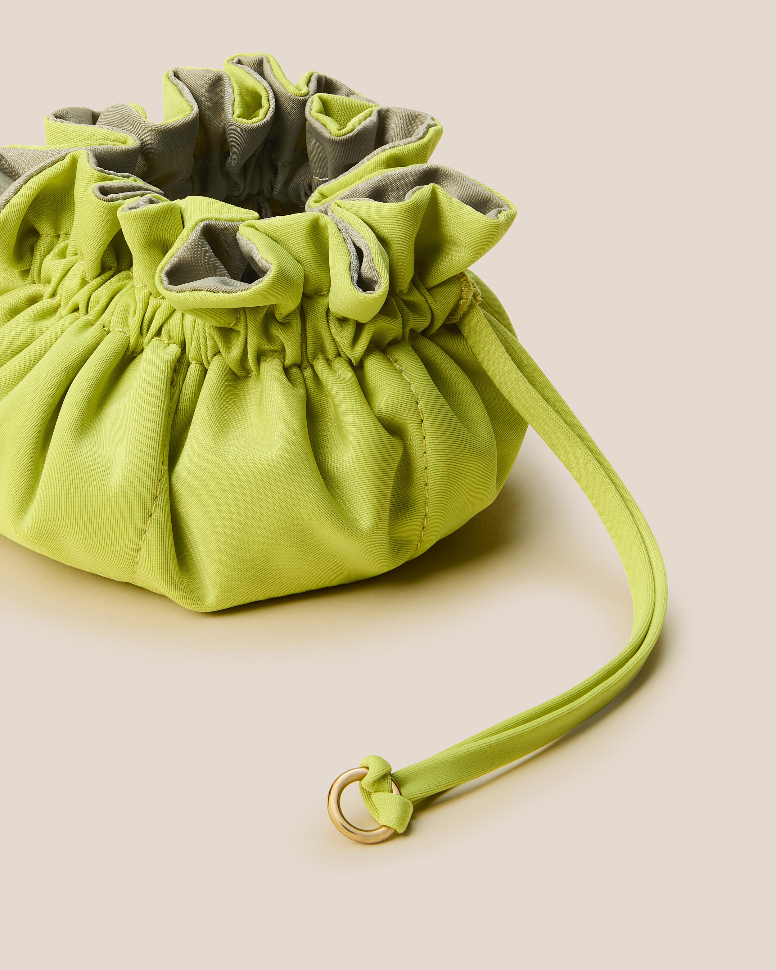 Lotus Jewelry Pouch in Matcha (Lotus) shown from a side angle, highlighting its  and drawstring closure.