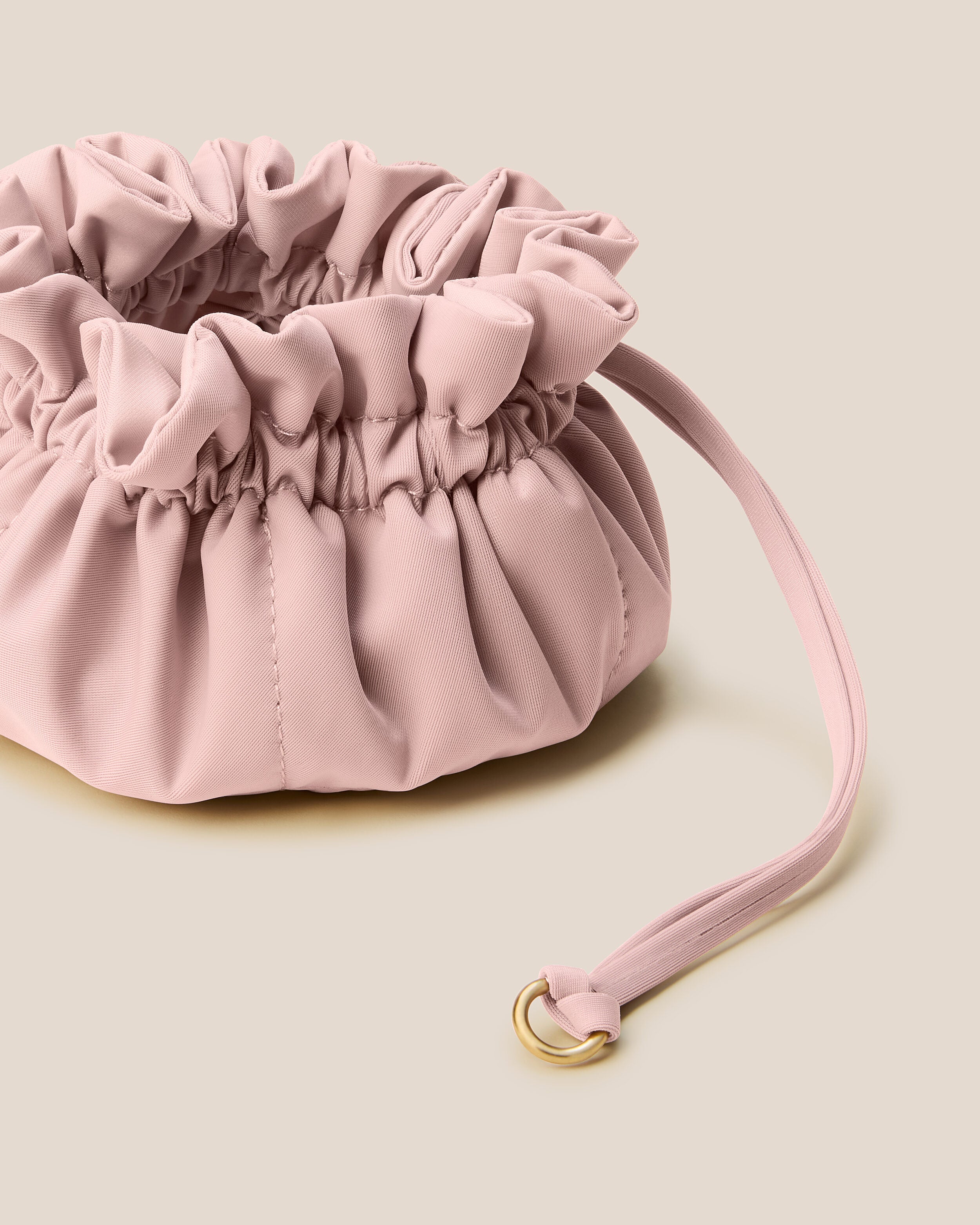 Lotus Jewelry Pouch in Petal shown from a side angle, highlighting its  and drawstring closure.