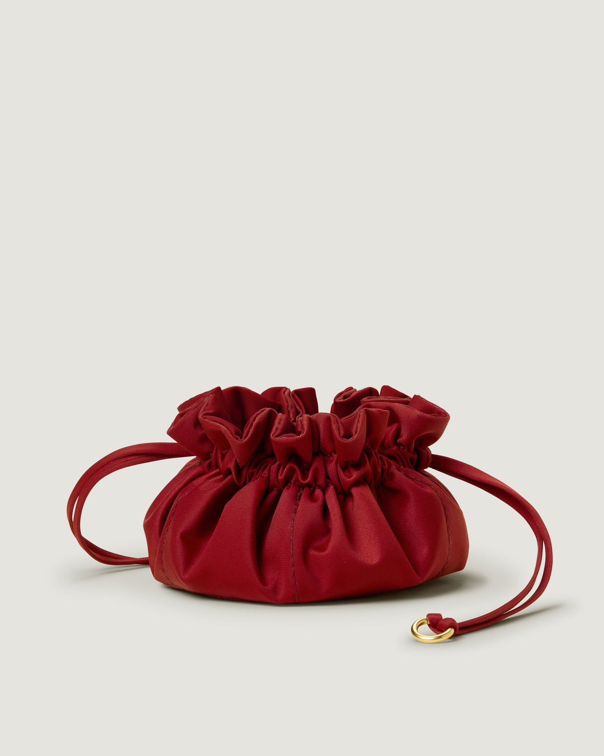 Lotus Jewelry Pouch in Rosso featuring a drawstring closure.