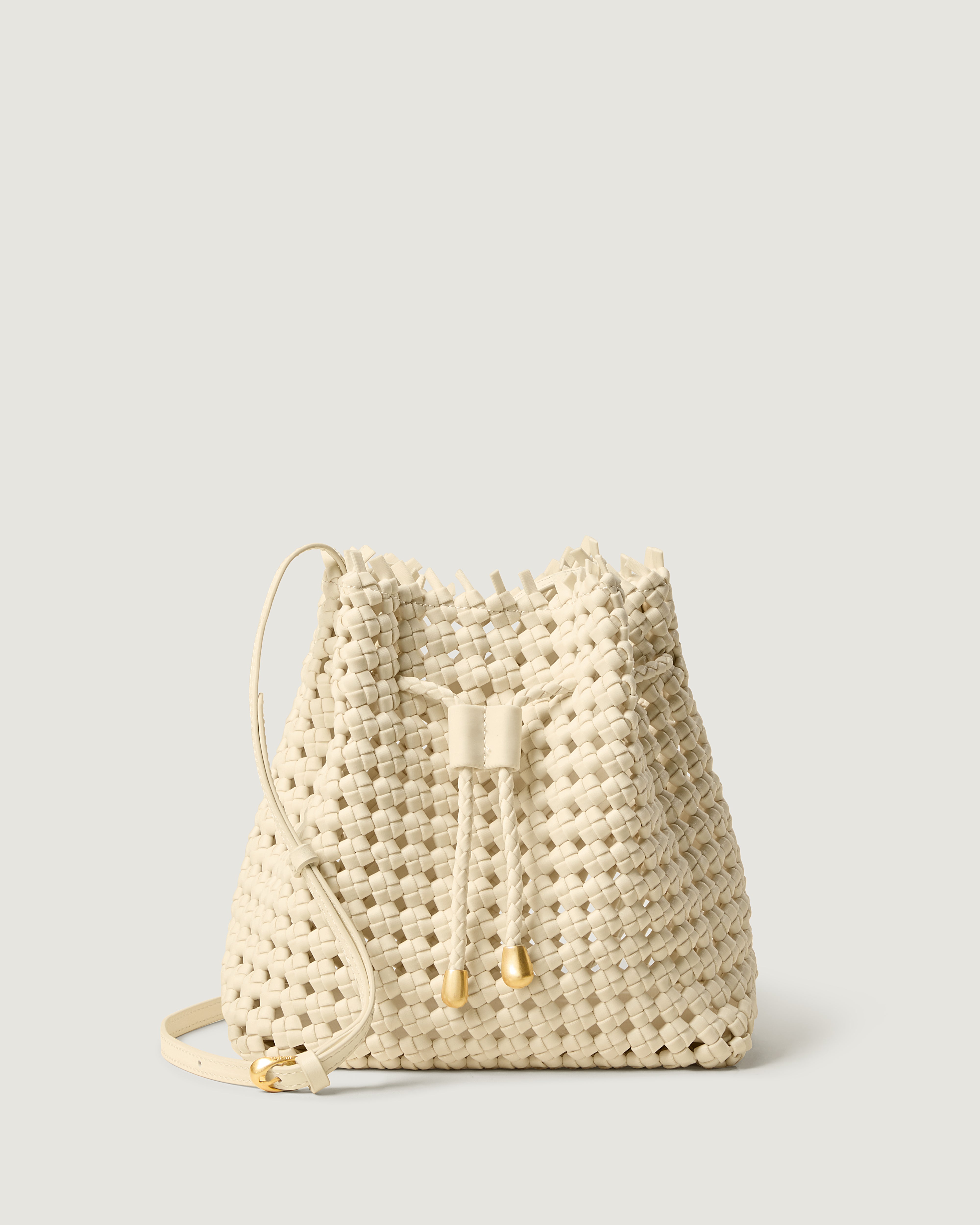 Mallorca Bucket in Salt, a bone white tone, in handwoven neoprene, featuring a drawstring closure, and adjustable leather crossbody strap.