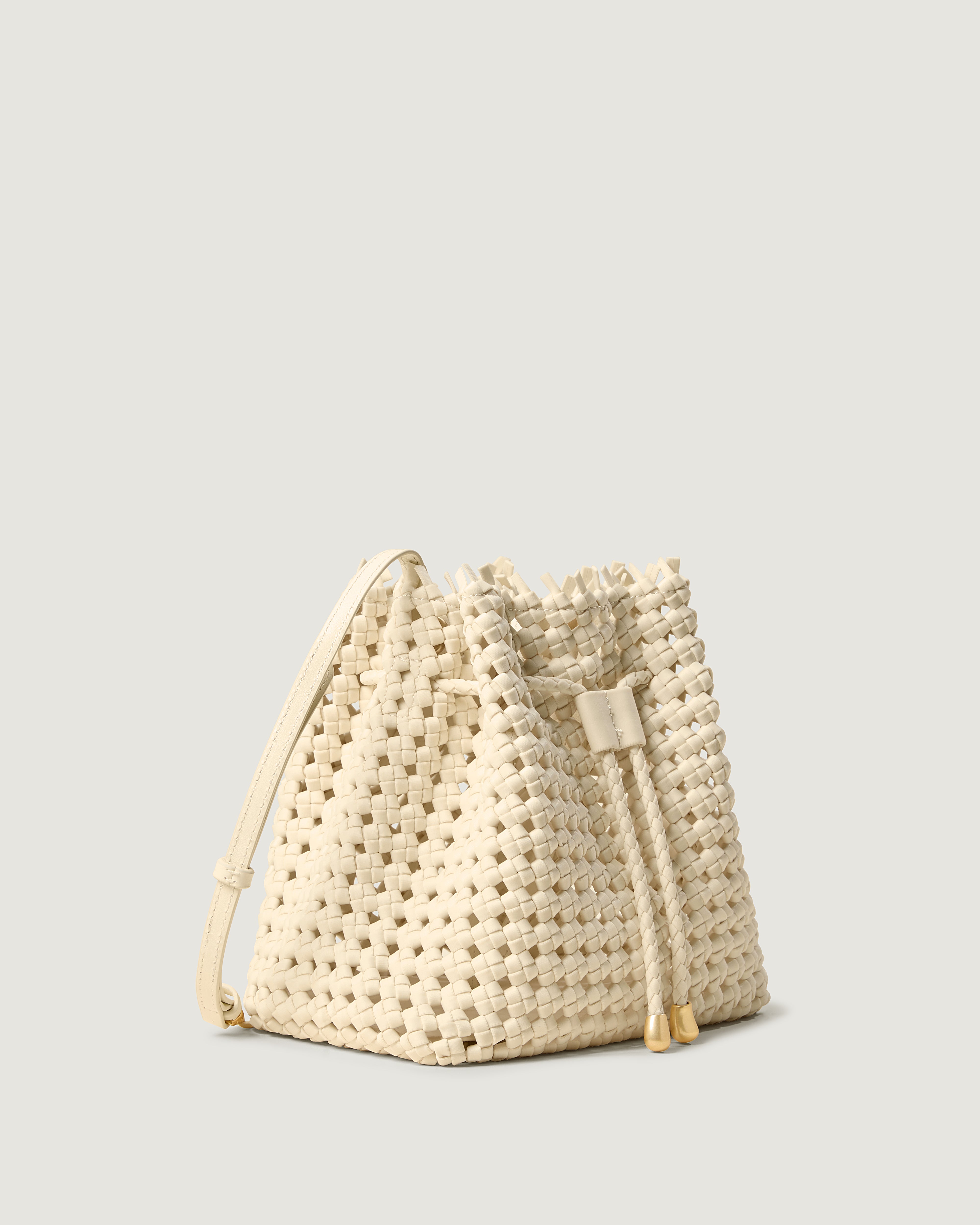 Mallorca Bucket in Salt shown from a side angle, highlighting its handwoven neoprene construction and drawstring closure.