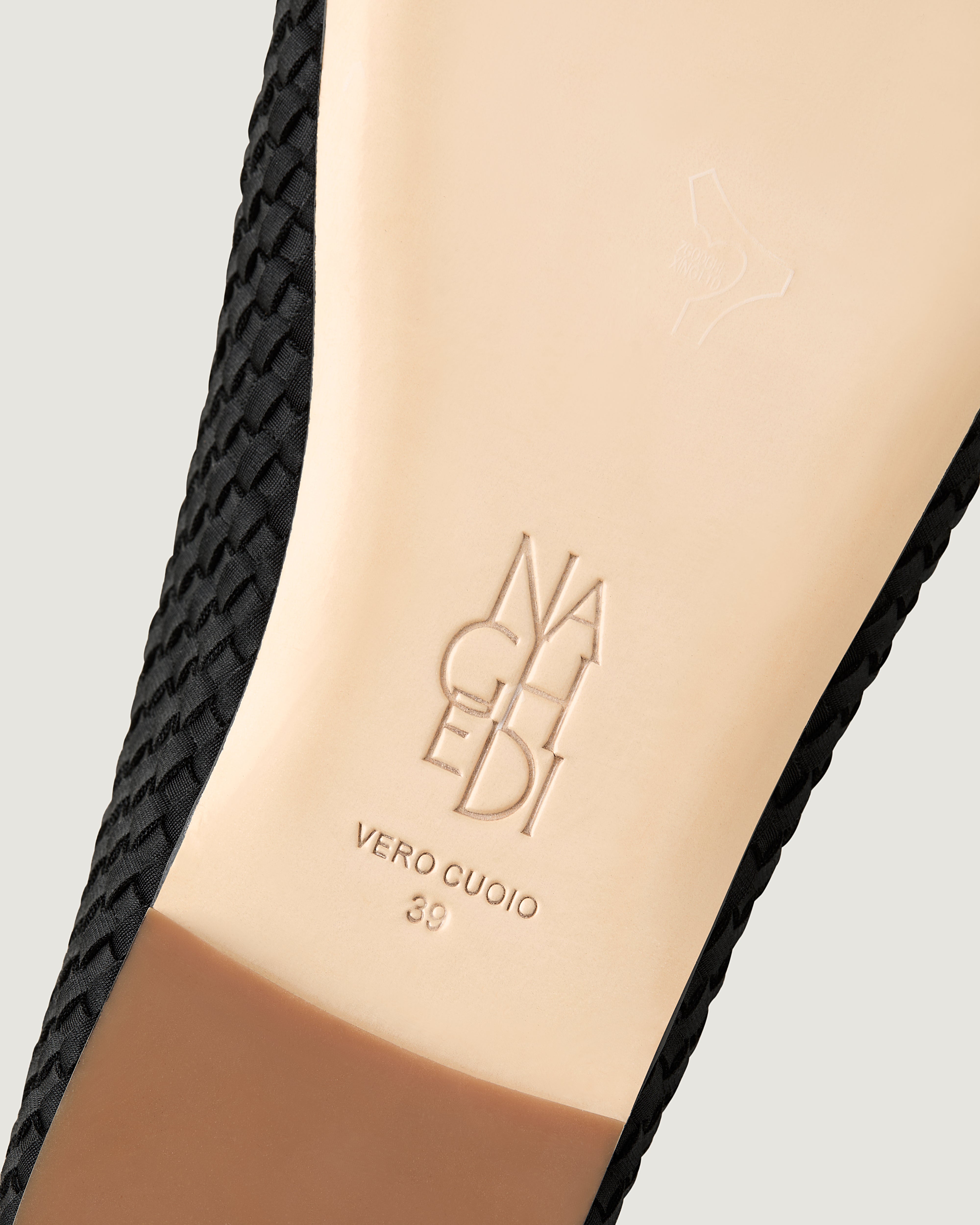 Shoe sole showing natural buffed leather sole, stamped NAGHEDI logo and size detail for The Marais Mary Jane in Onyx.