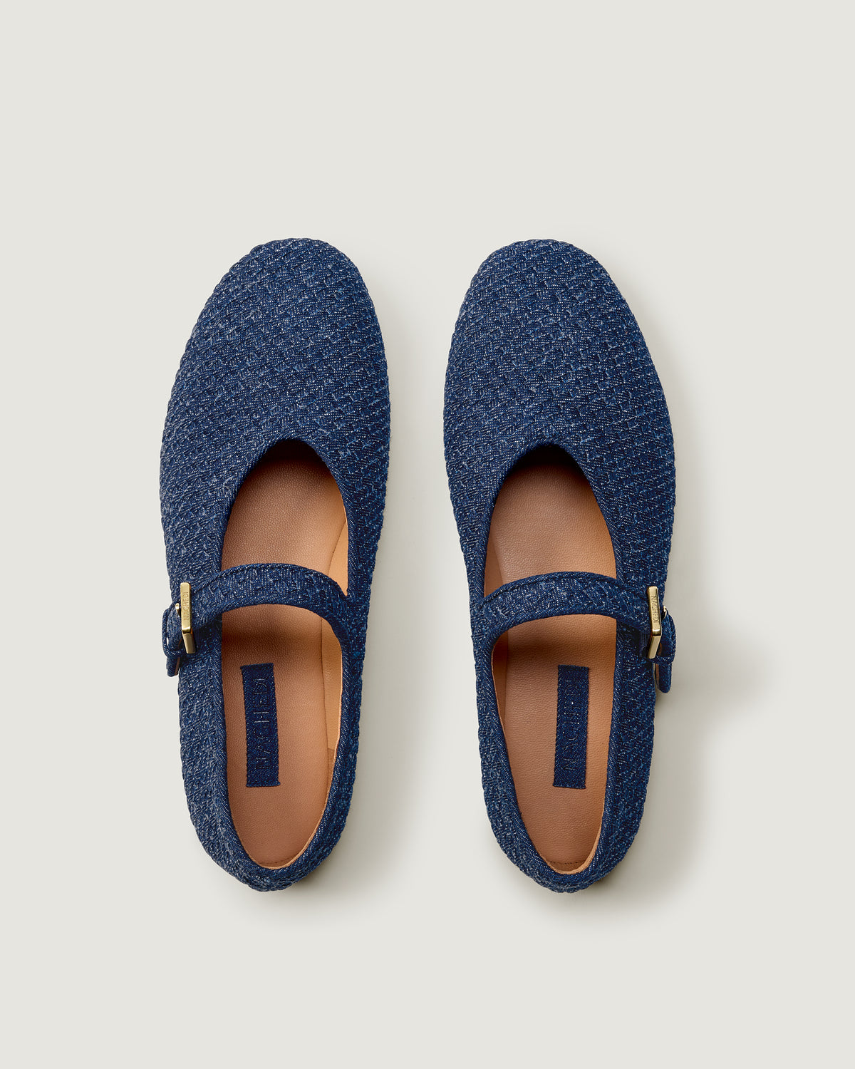 Top view of pair of The Marais Mary Jane in Denim showing the natural tanned leather insole.