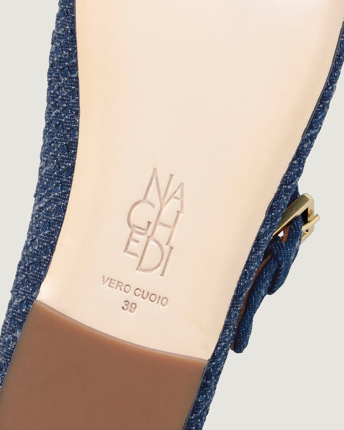 Shoe sole showing natural buffed leather sole, stamped NAGHEDI logo and size detail for The Marais Mary Jane in Denim.