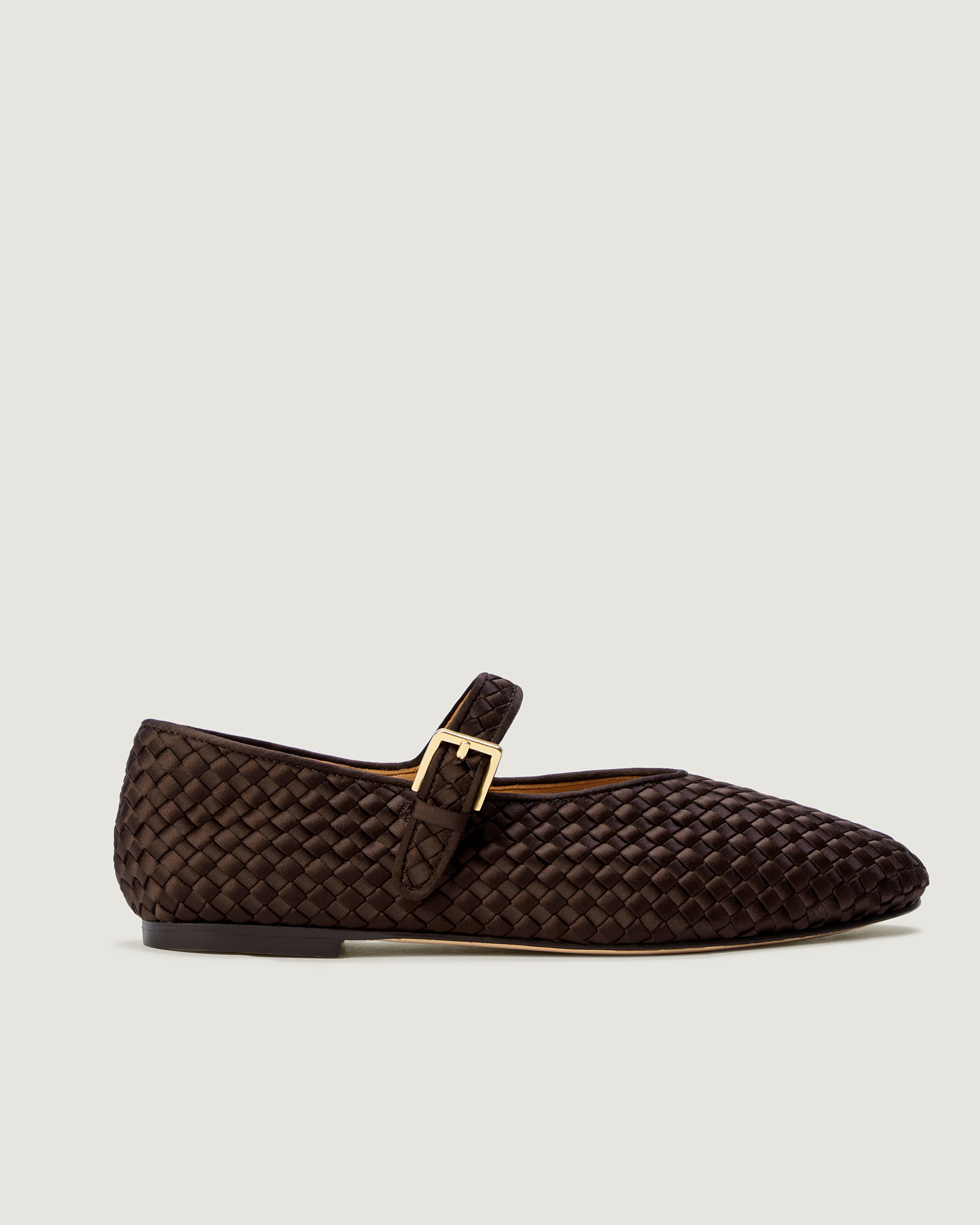 Side view of The Marais Mary Jane in Chocolate, a deep brown tone, featuring a closed toe and round silhouette, featuring an adjustable strap with buckle closure.