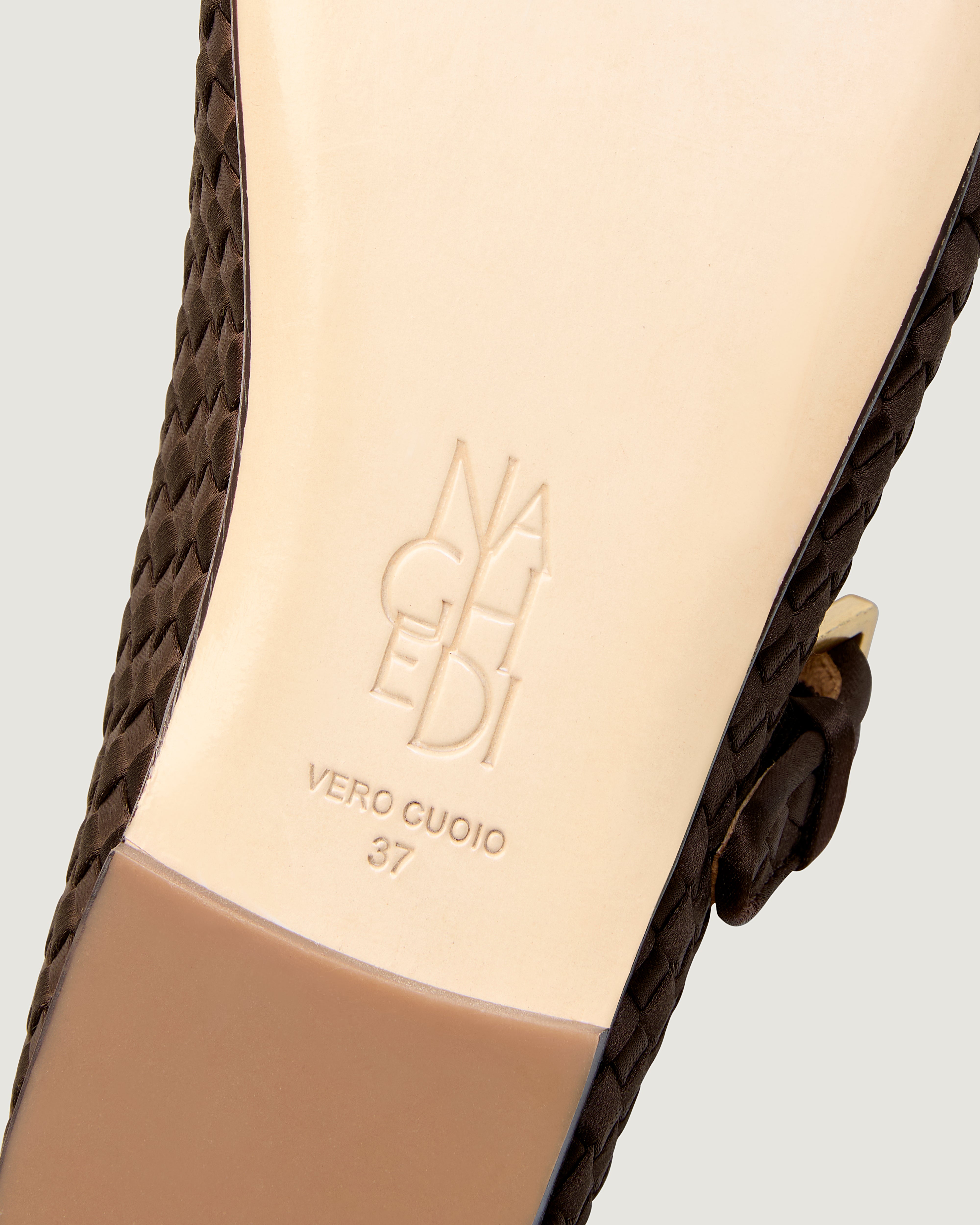 Shoe sole showing natural buffed leather sole, stamped NAGHEDI logo and size detail for The Marais Mary Jane in Chocolate.