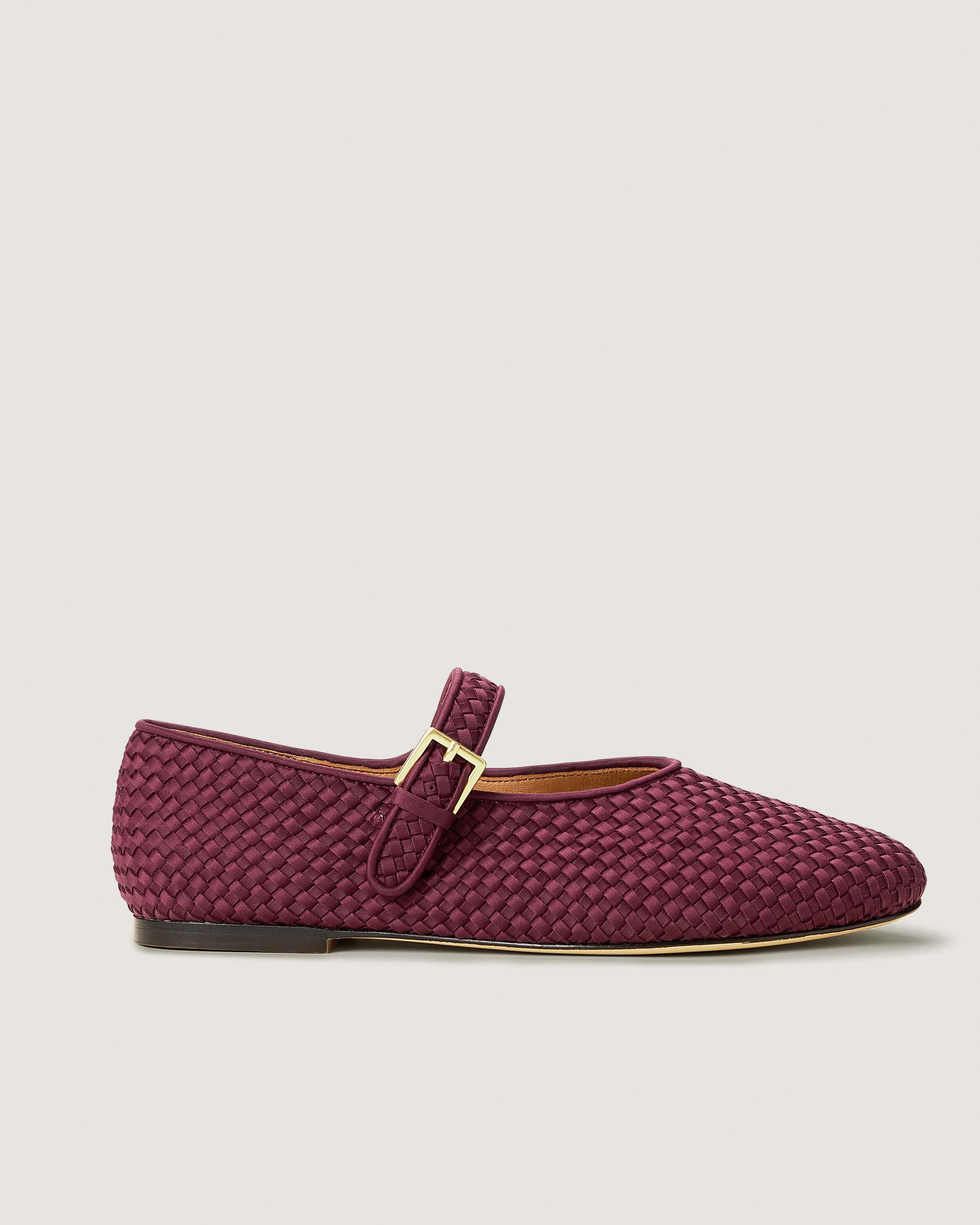 Side view of The Marais Mary Jane in Bordeaux, a rich burgundy tone, featuring a closed toe and round silhouette, featuring an adjustable strap with buckle closure.