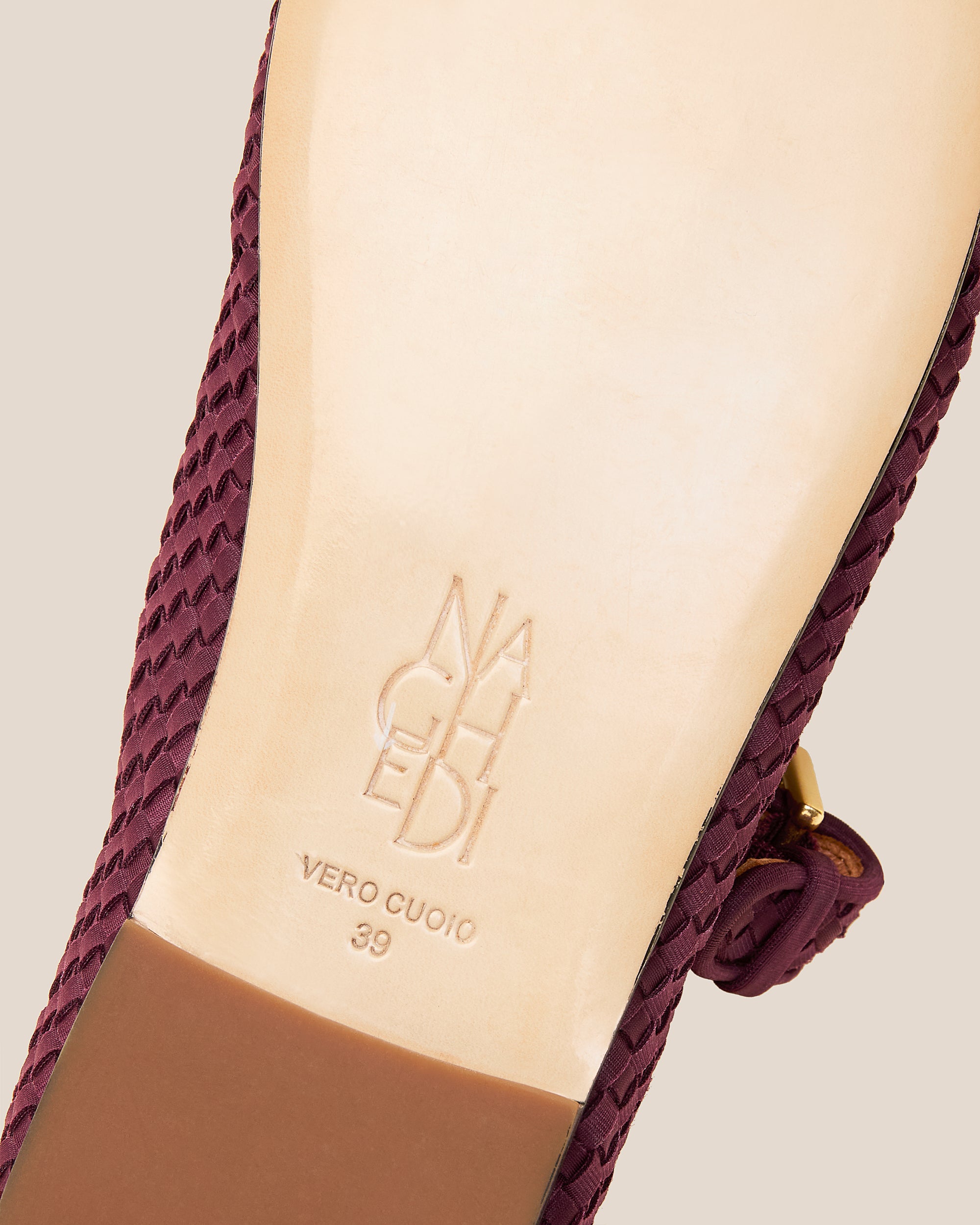 Shoe sole showing natural buffed leather sole, stamped NAGHEDI logo and size detail for Marais Mary Jane Flats in Bordeaux.