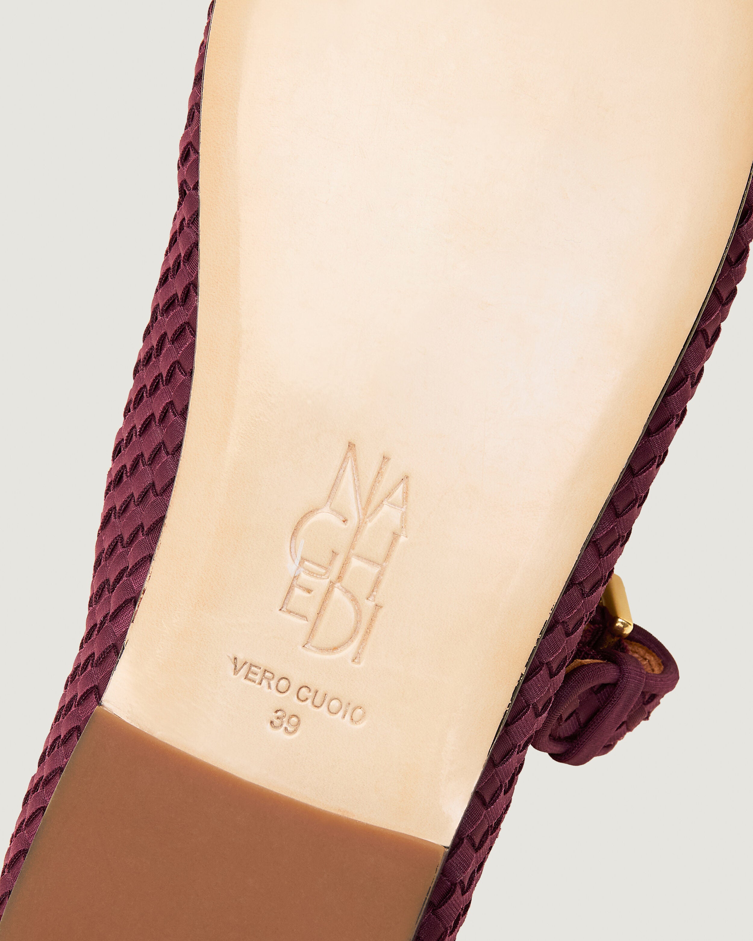 Shoe sole showing natural buffed leather sole, stamped NAGHEDI logo and size detail for The Marais Mary Jane in Bordeaux.