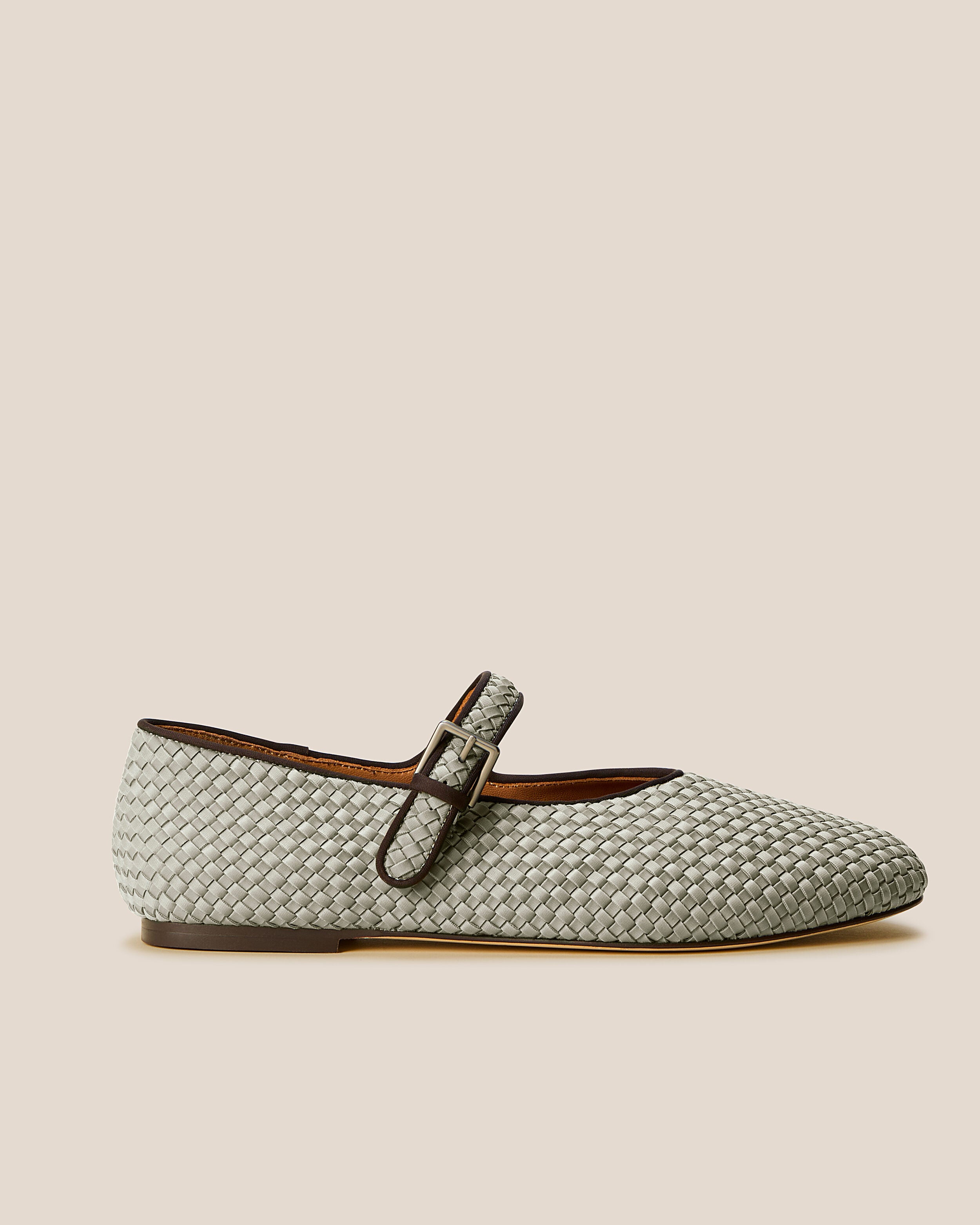 Side view of The Marais Mary Jane in Celadon, a light jade green tone, featuring a closed toe and round silhouette, featuring an adjustable strap with buckle closure.