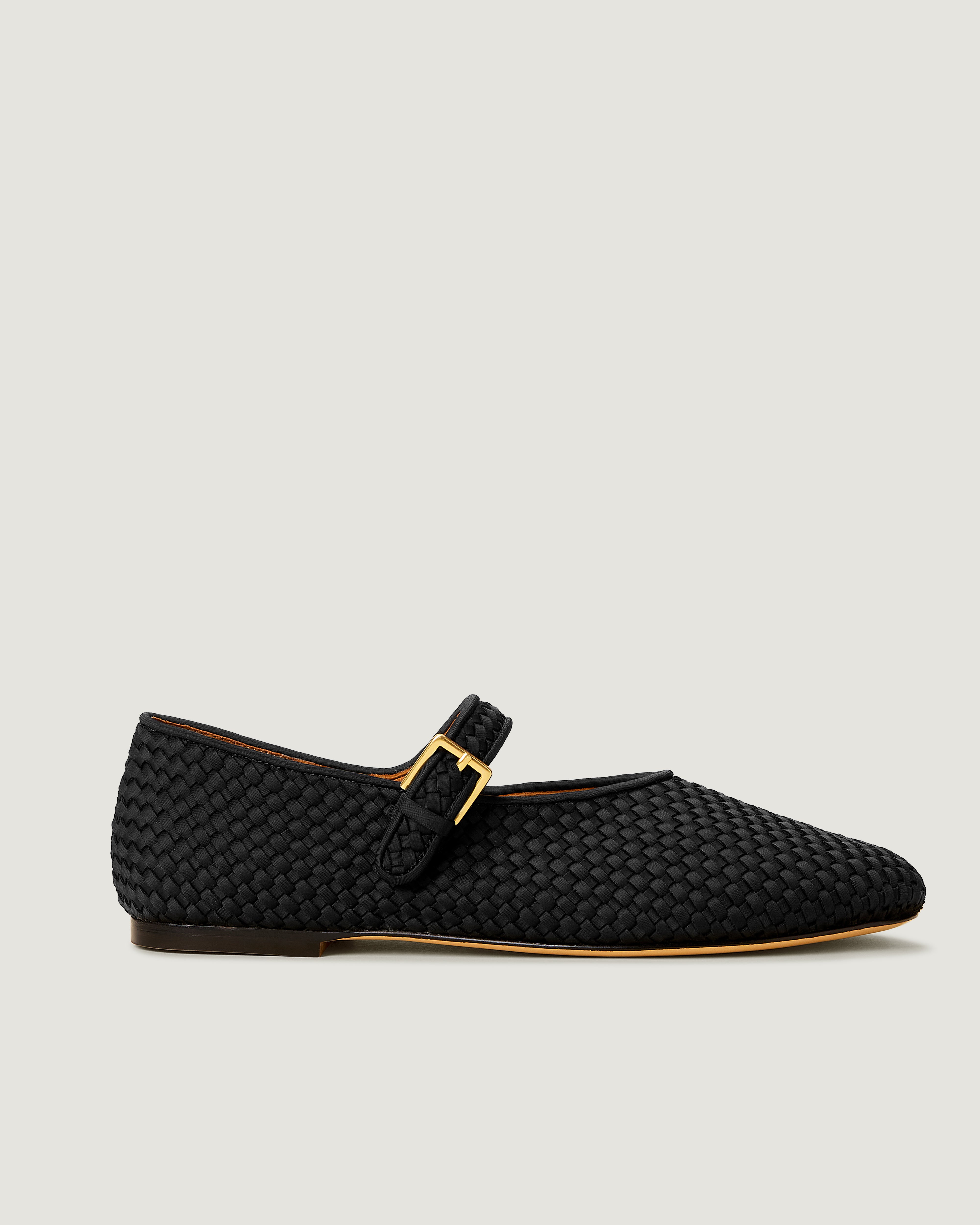 Side view of The Marais Mary Jane in Onyx, a true black tone, featuring a closed toe and round silhouette, featuring an adjustable strap with buckle closure.