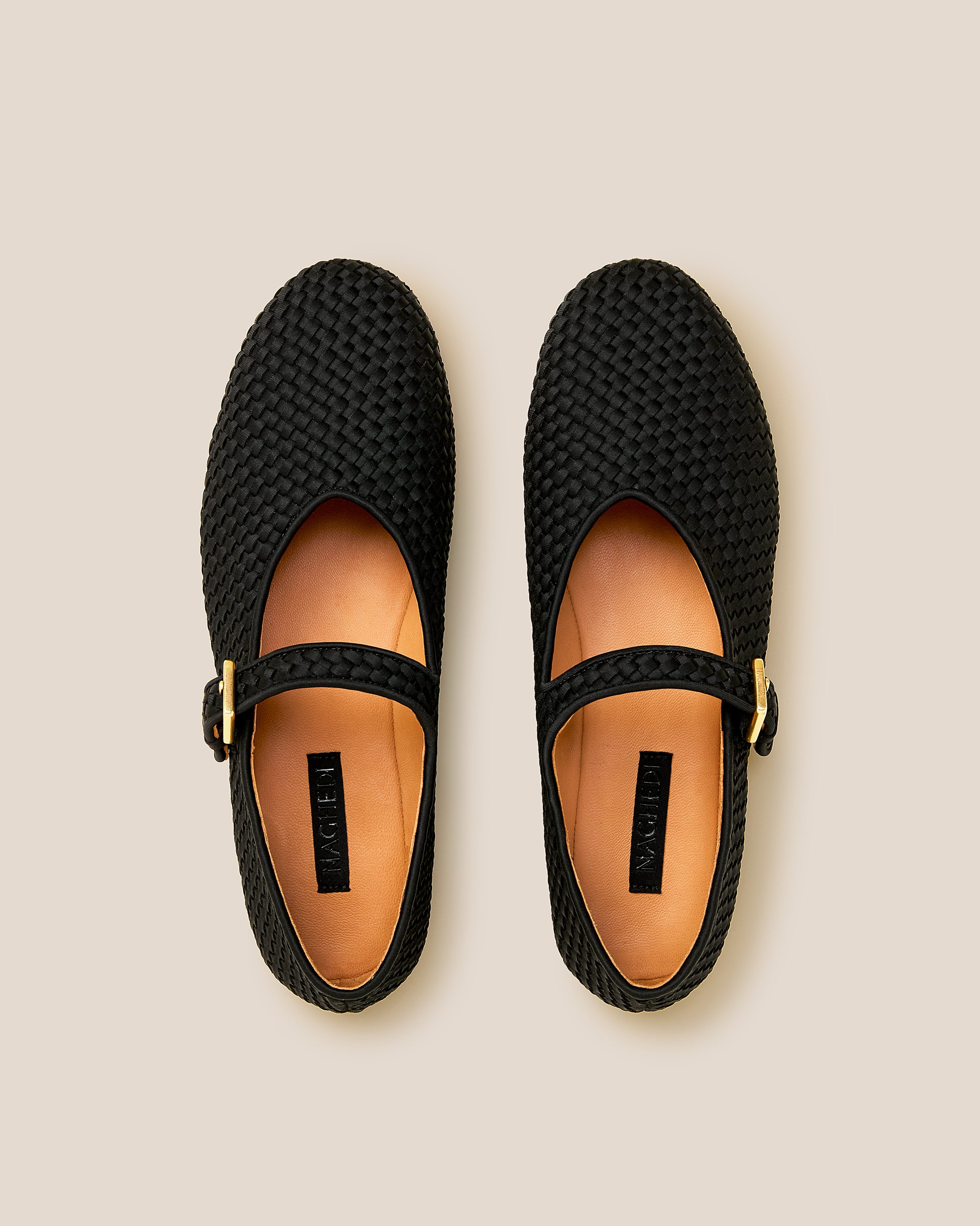 Top view of pair of Marais Mary Jane Flats in Onyx showing the natural tanned leather insole.