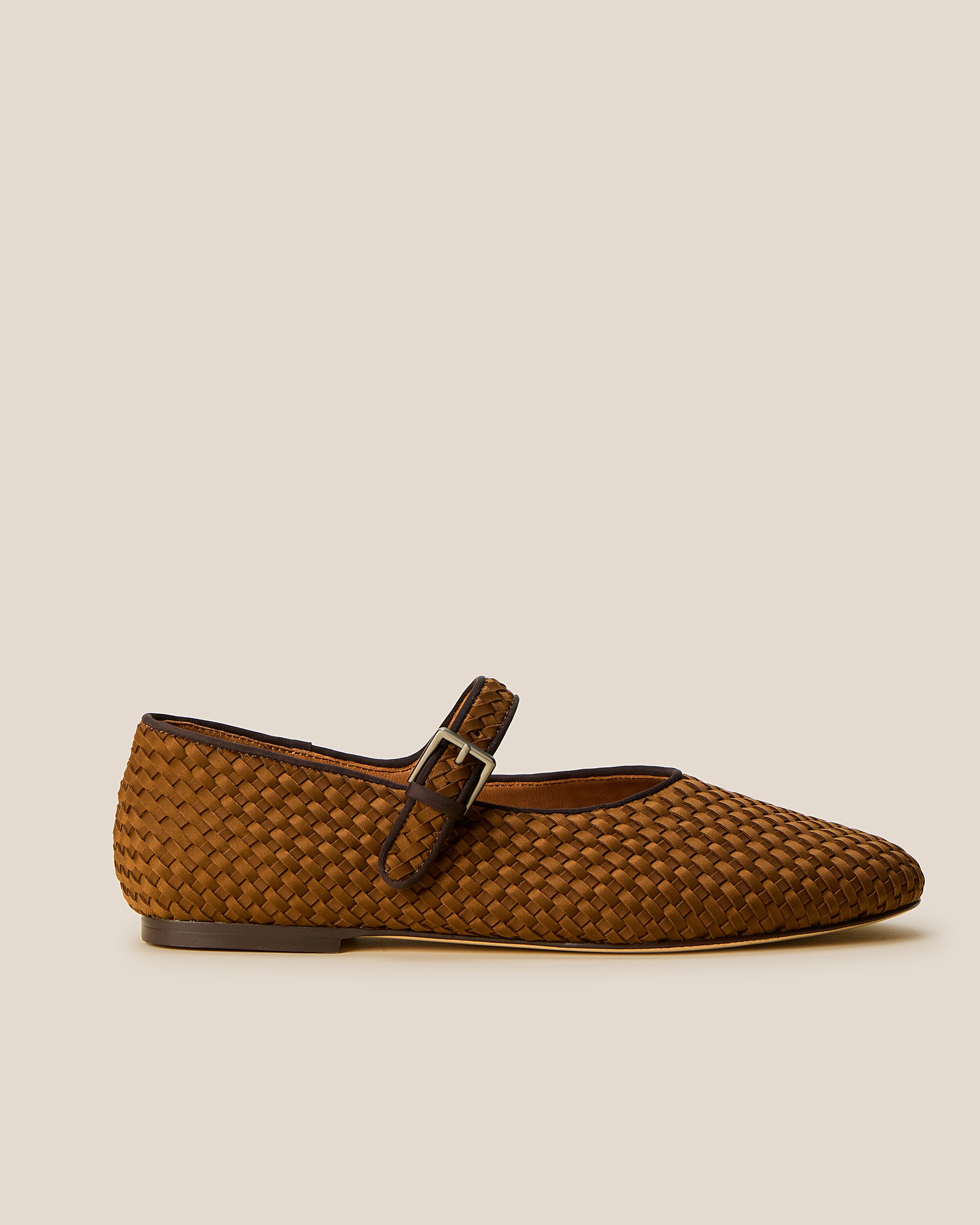 Side view of The Marais Mary Jane in Teak, a saddle brown tone, featuring a closed toe and round silhouette, featuring an adjustable strap with buckle closure.