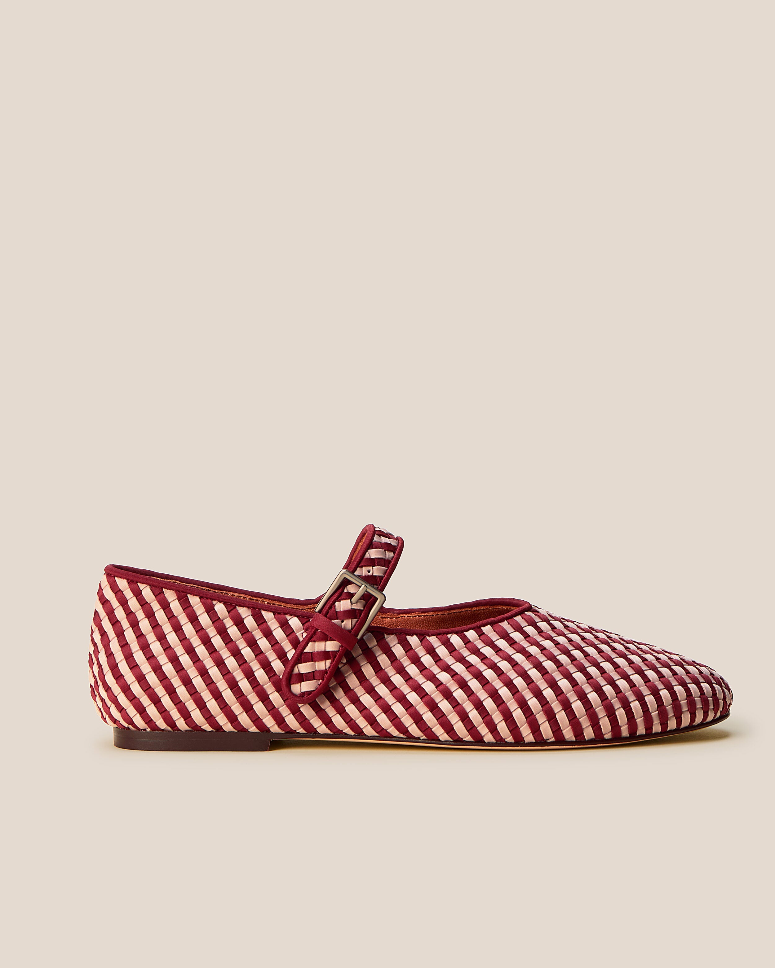 Side view of The Marais Mary Jane in Lychee, a rich red and soft ballet pink tone, featuring a closed toe and round silhouette, featuring an adjustable strap with buckle closure.