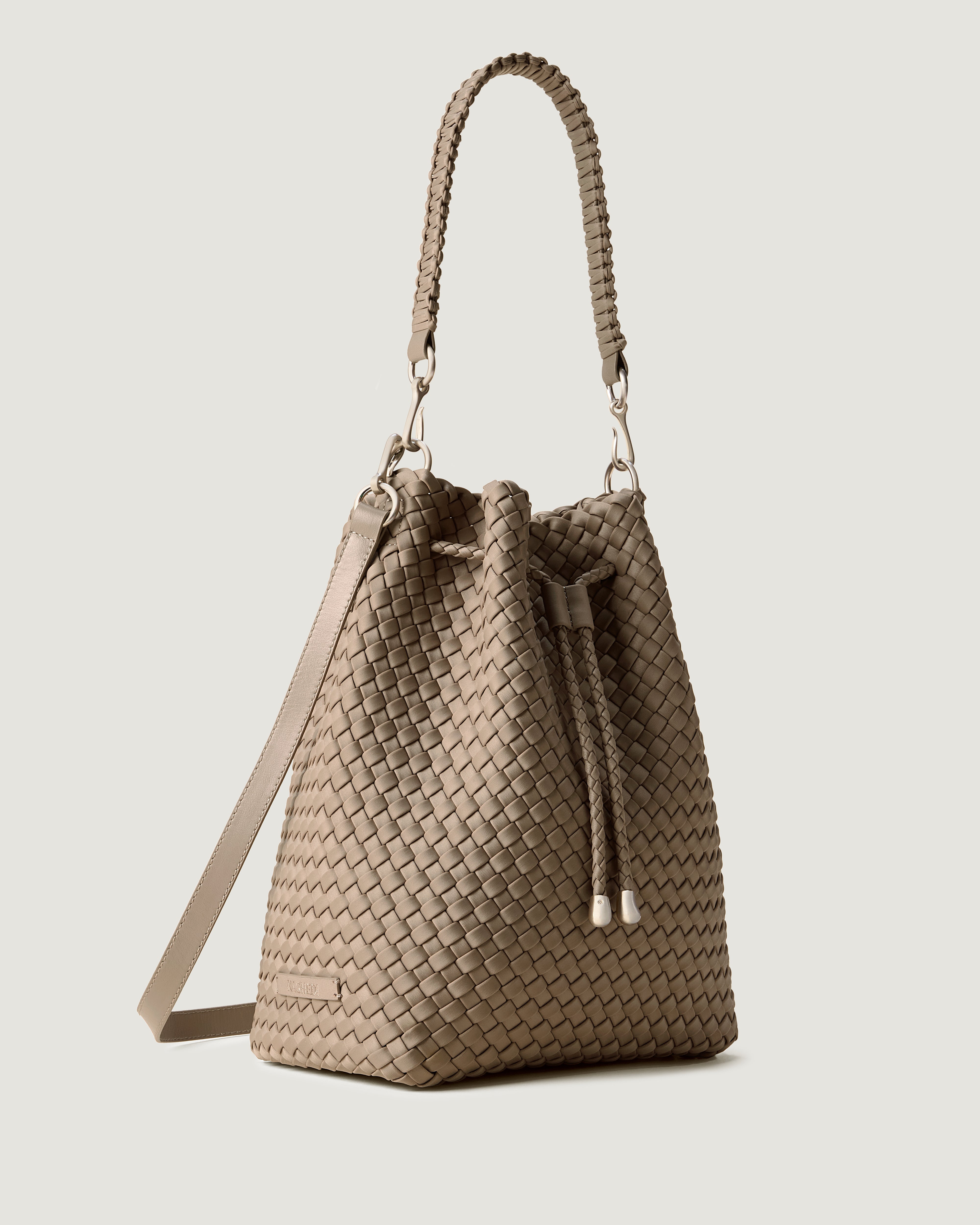Mercer Bucket in Cashmere shown from a side angle, highlighting its handwoven neoprene construction and drawstring closure.
