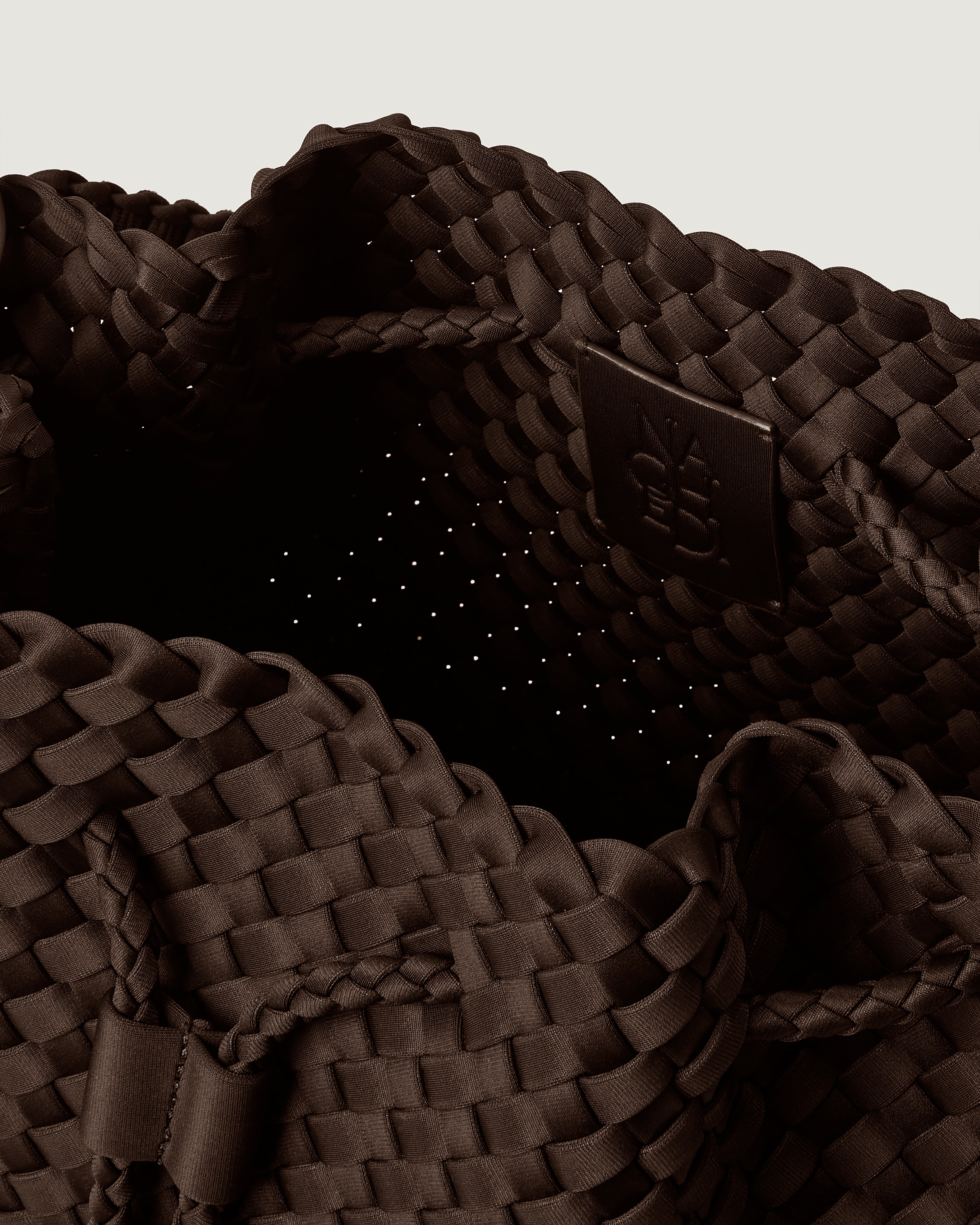 Interior close-up of Mercer Bucket in Chocolate showing its drawstring closure, and unlined interior.