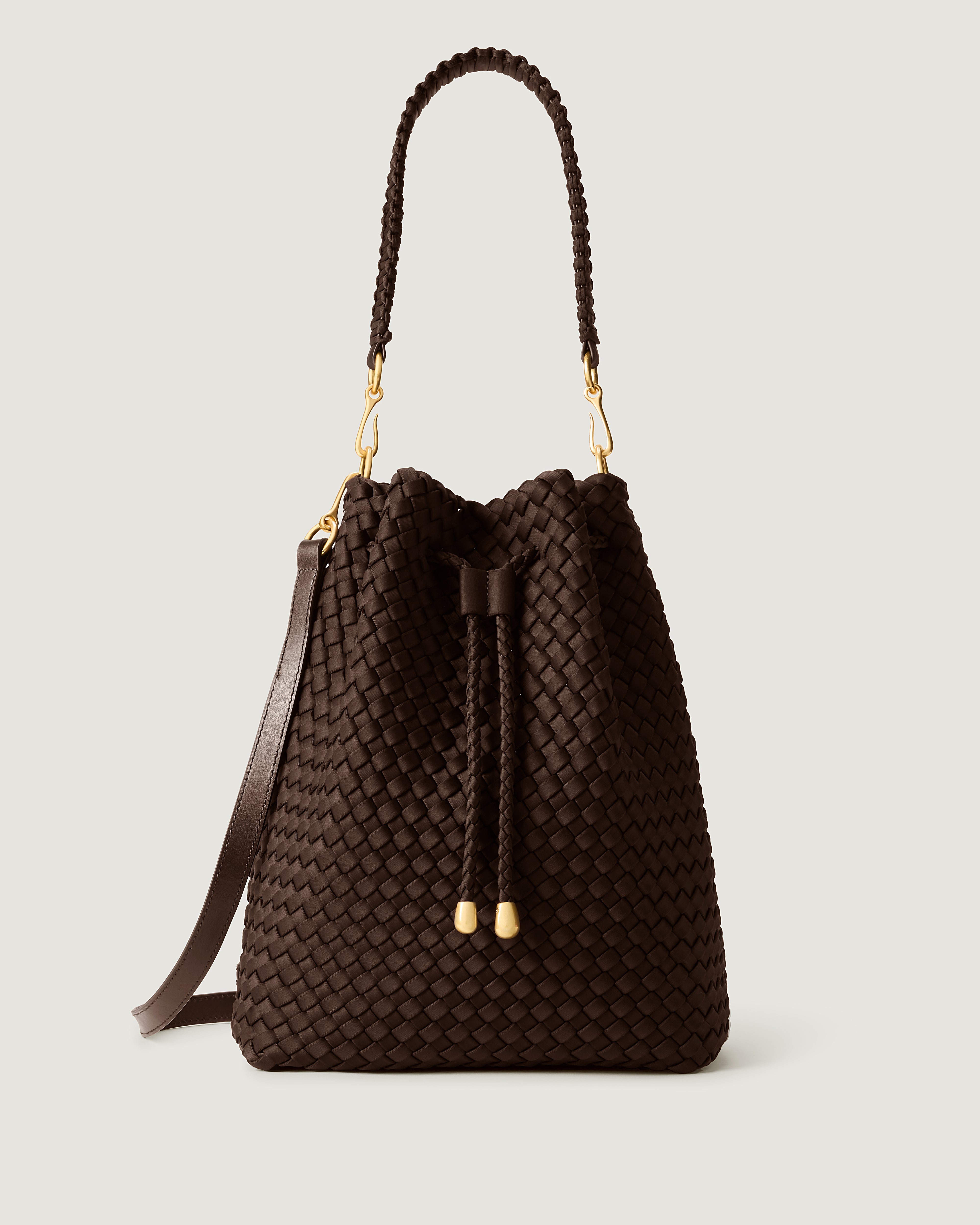 Mercer Bucket in Chocolate, a dark chocolate brown tone, in handwoven neoprene, featuring a drawstring closure, and removable, adjustable leather crossbody strap.