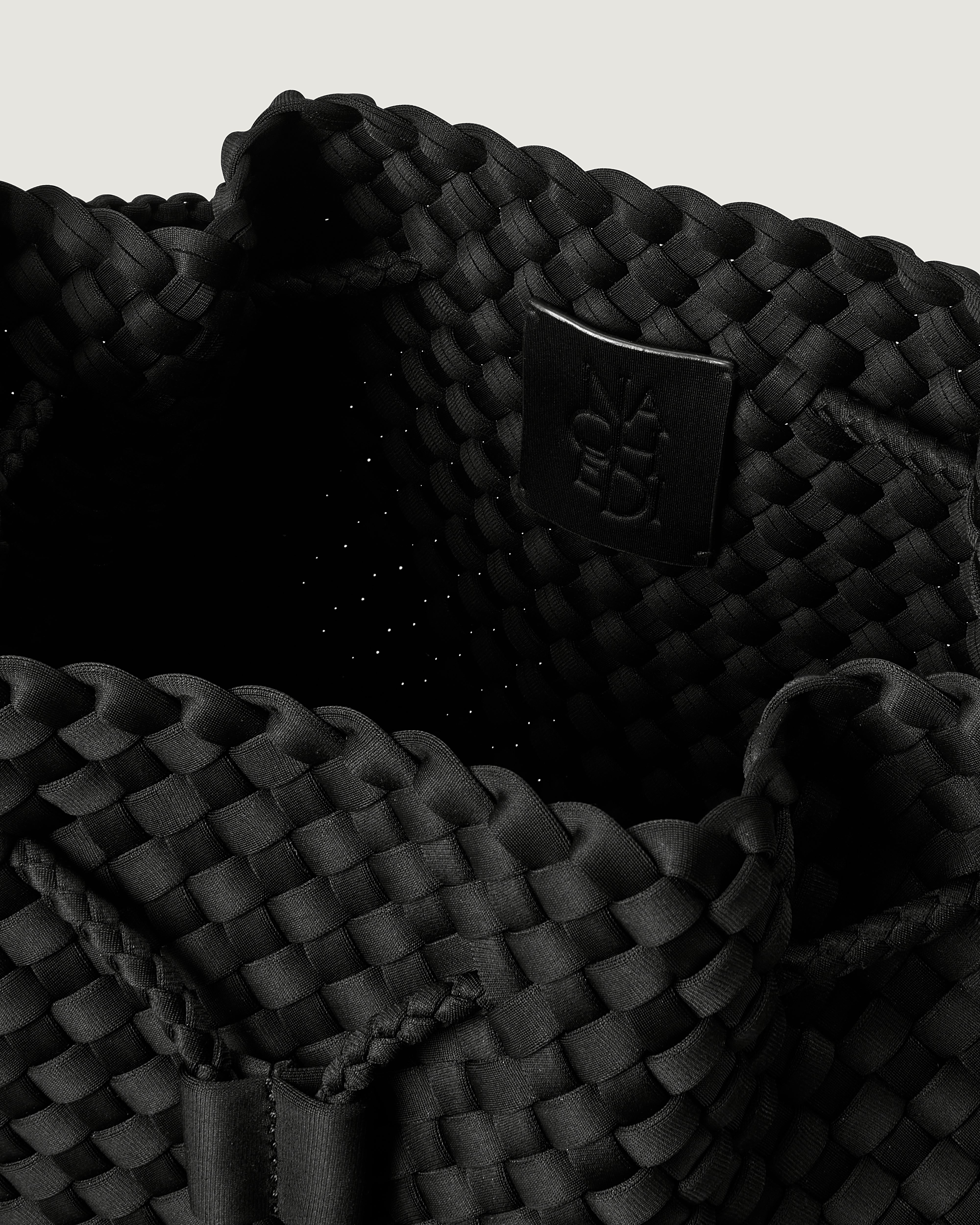 Interior close-up of Mercer Bucket in Onyx showing its drawstring closure, and unlined interior.