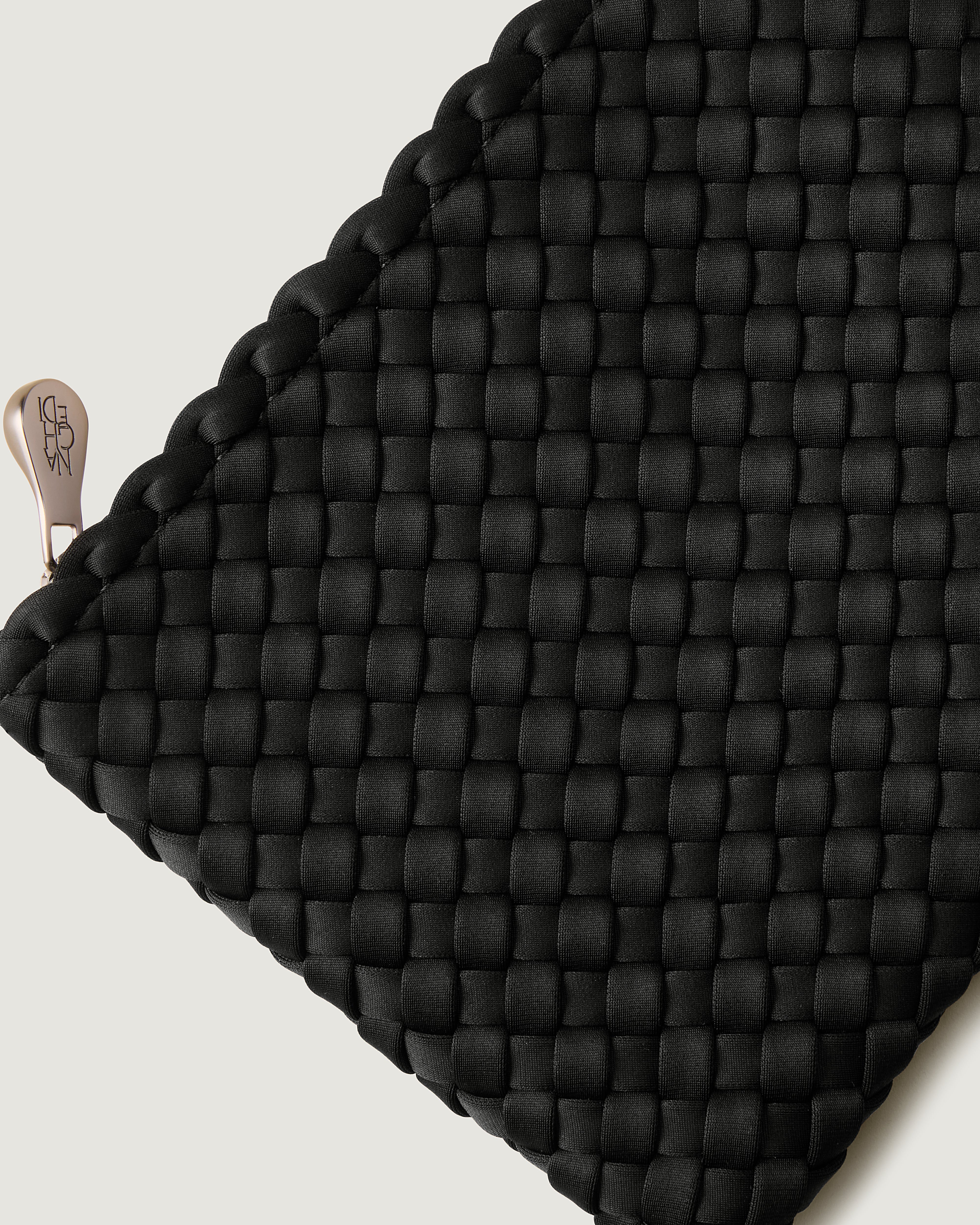 Close-up of included matching woven zippered pouch.