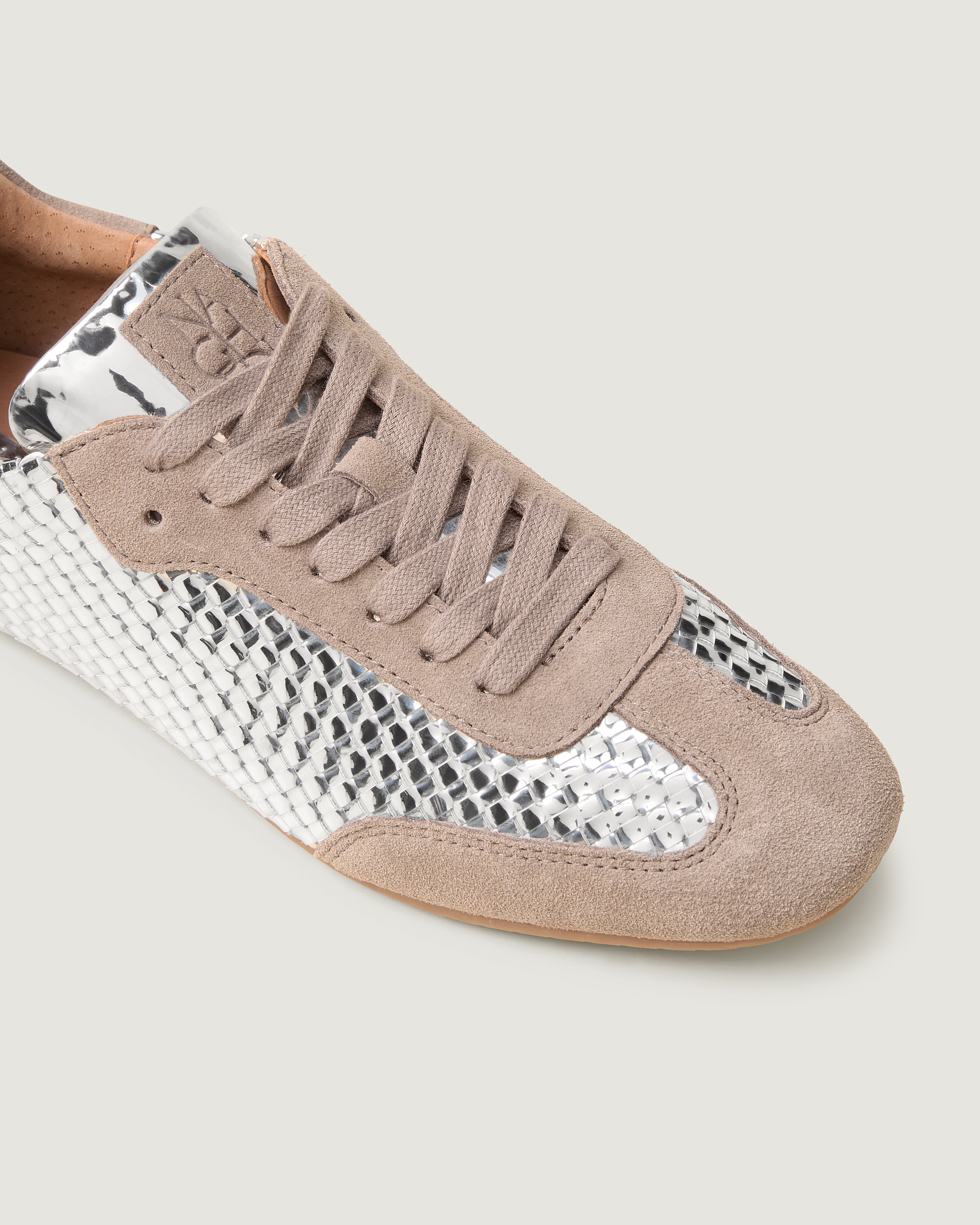 Close-up of The Milan Sneaker in Salt showing its suede trim.
