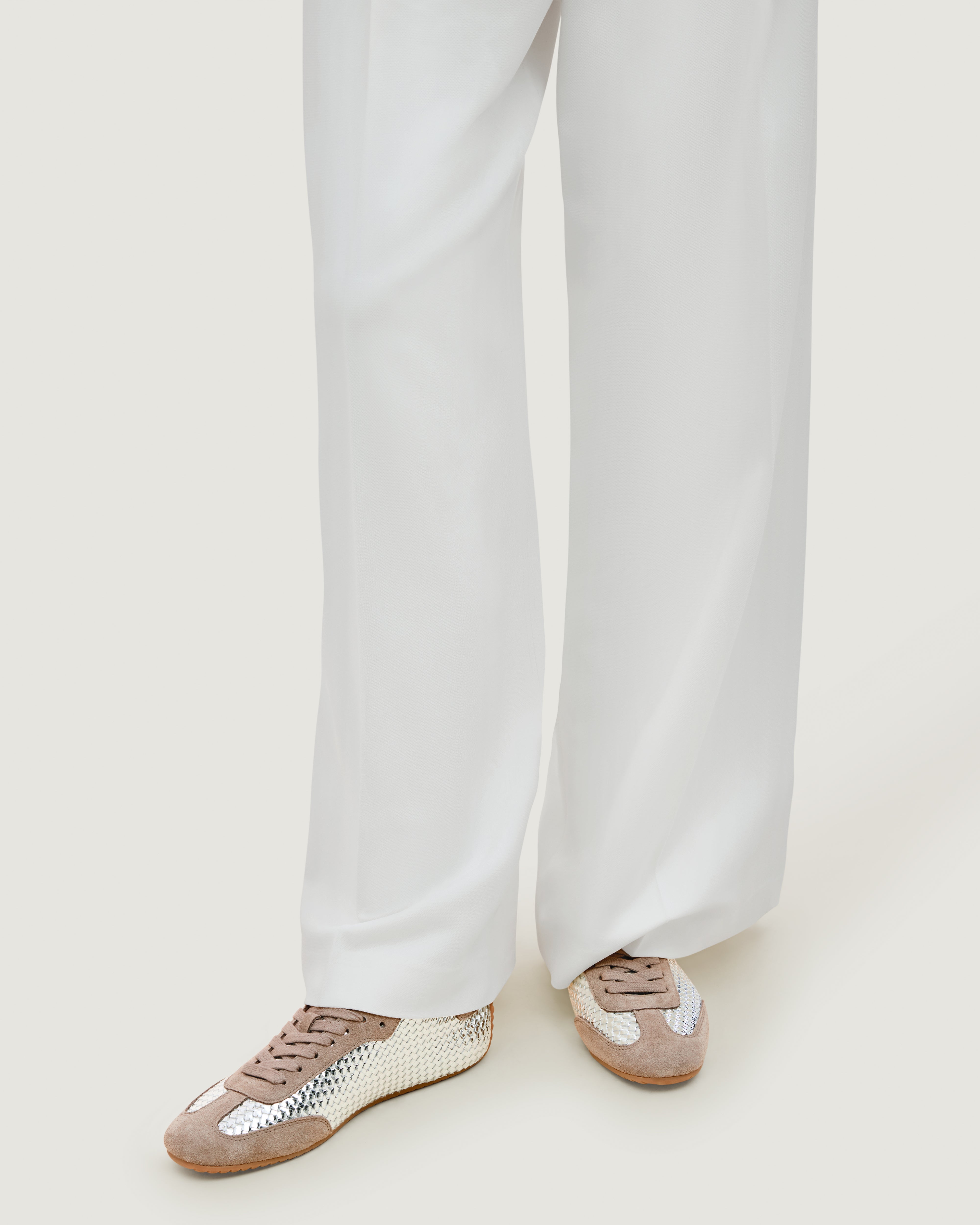 The Milan Sneaker in Silver shown on model.