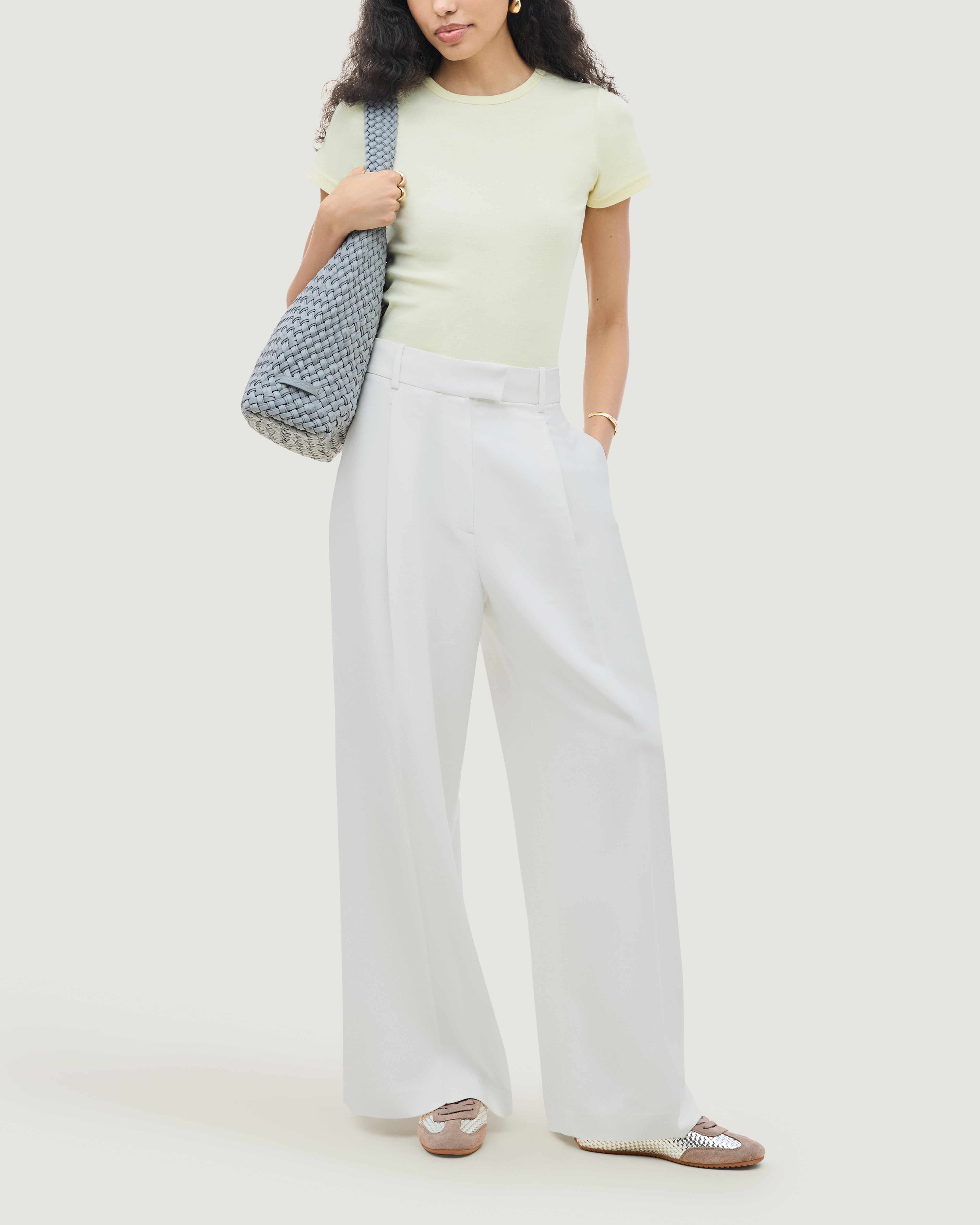The Milan Sneaker in Silver shown on model.