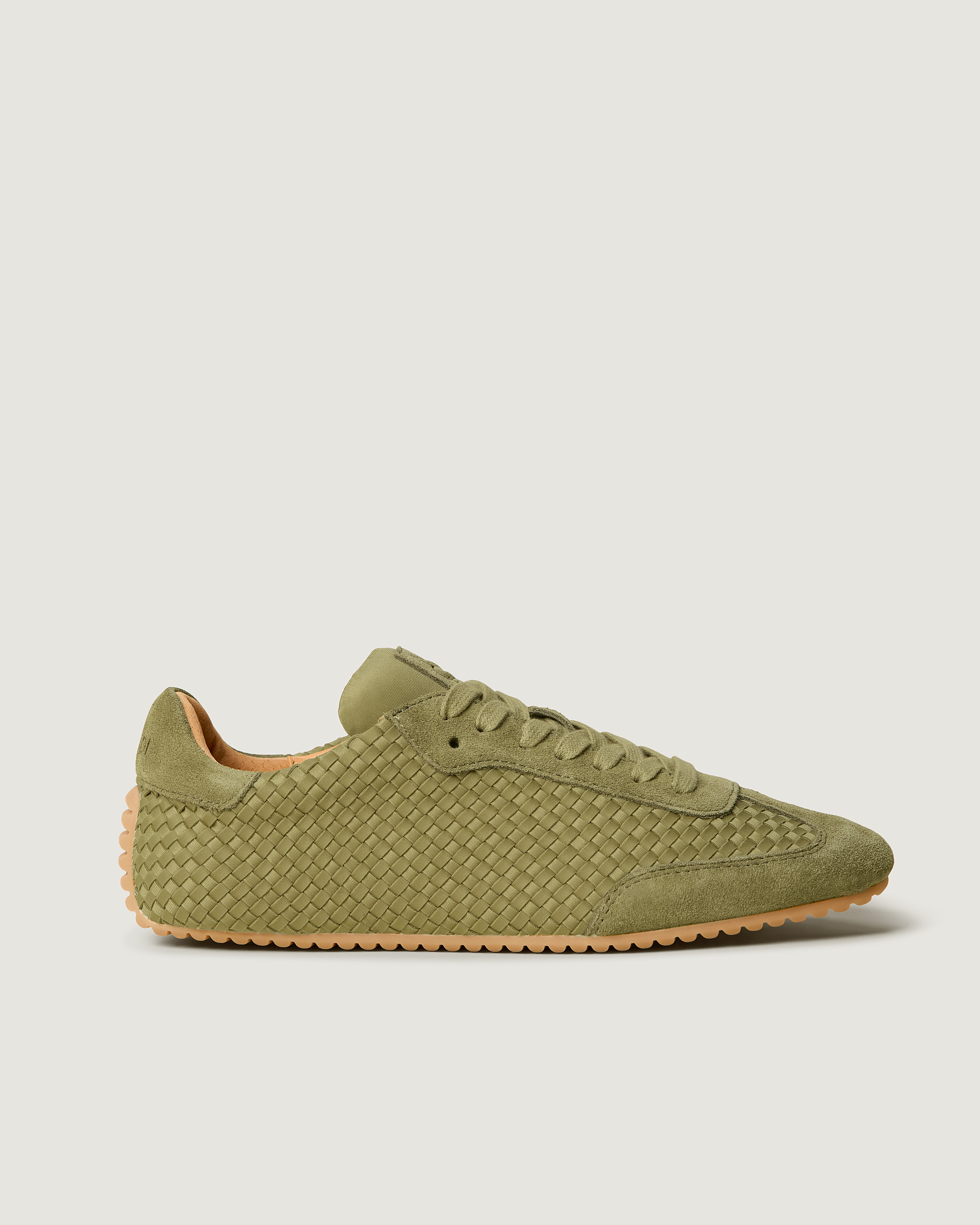 Side view of The Milan Sneaker in muted Bottle Green, featuring a closed toe and almond silhouette.