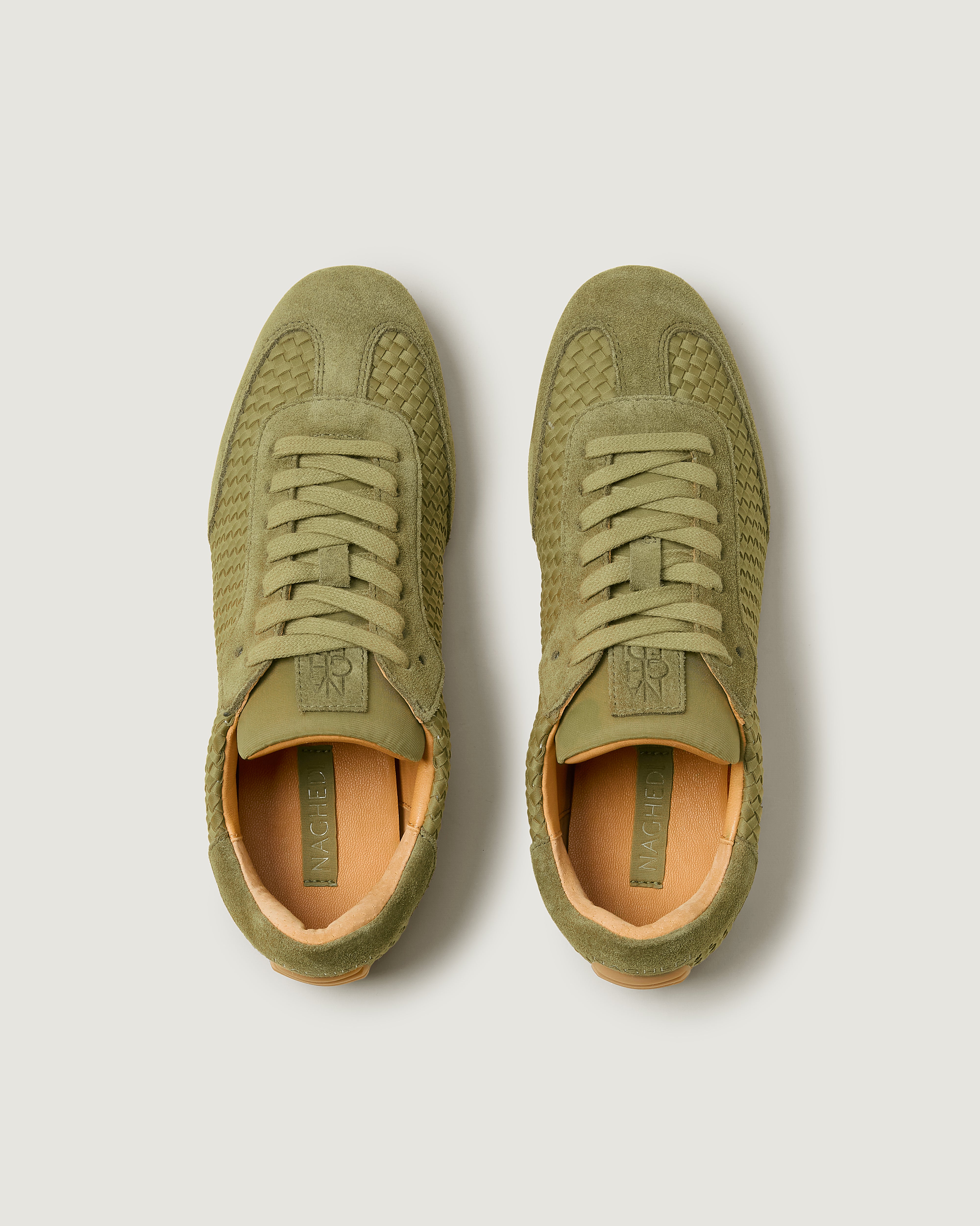 Top view of pair of The Milan Sneaker in Bottle Green showing the natural tanned leather insole.