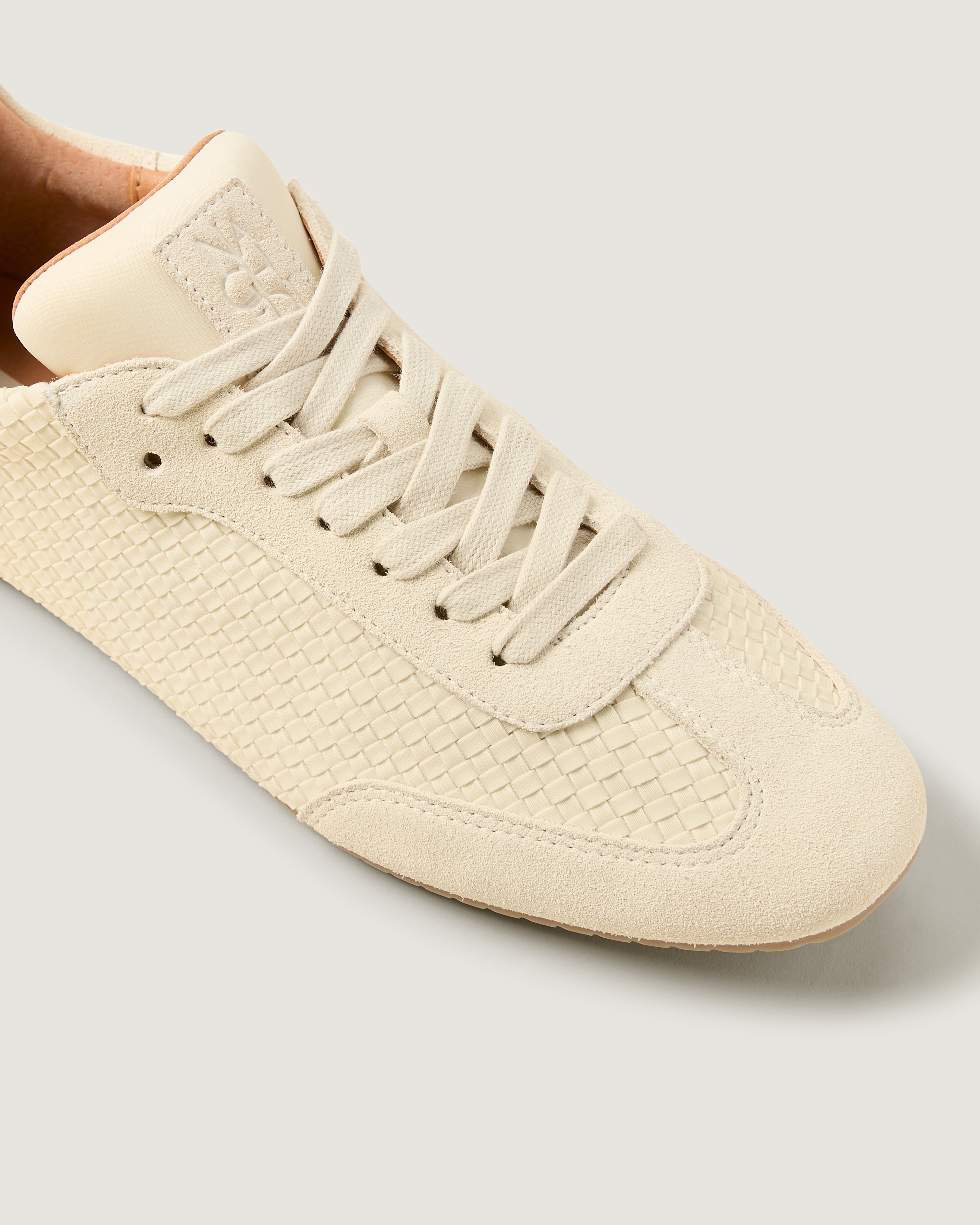 Close-up of The Milan Sneaker in Salt showing its tonal suede trim.