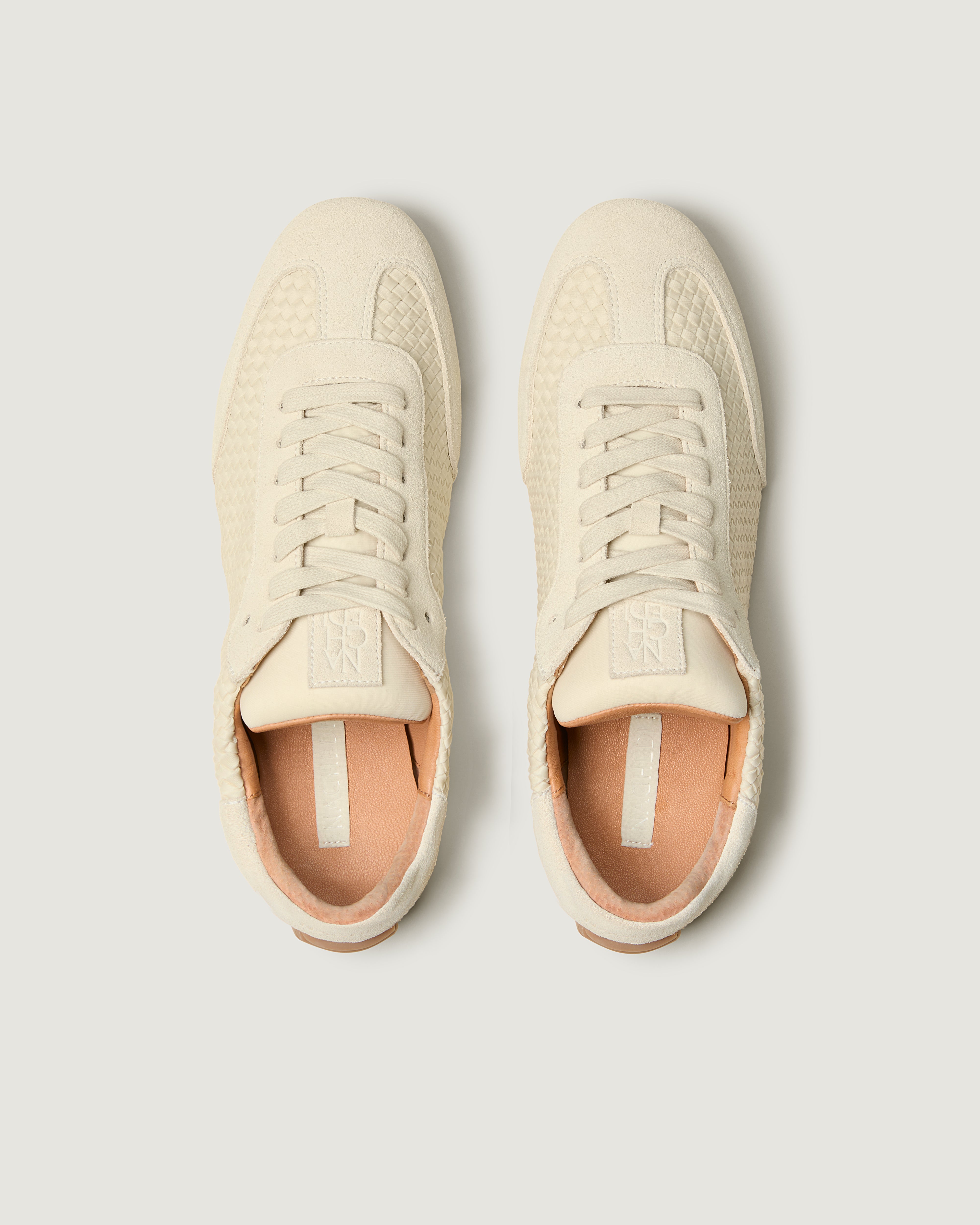 Top view of pair of The Milan Sneaker in Salt showing the natural tanned leather insole.