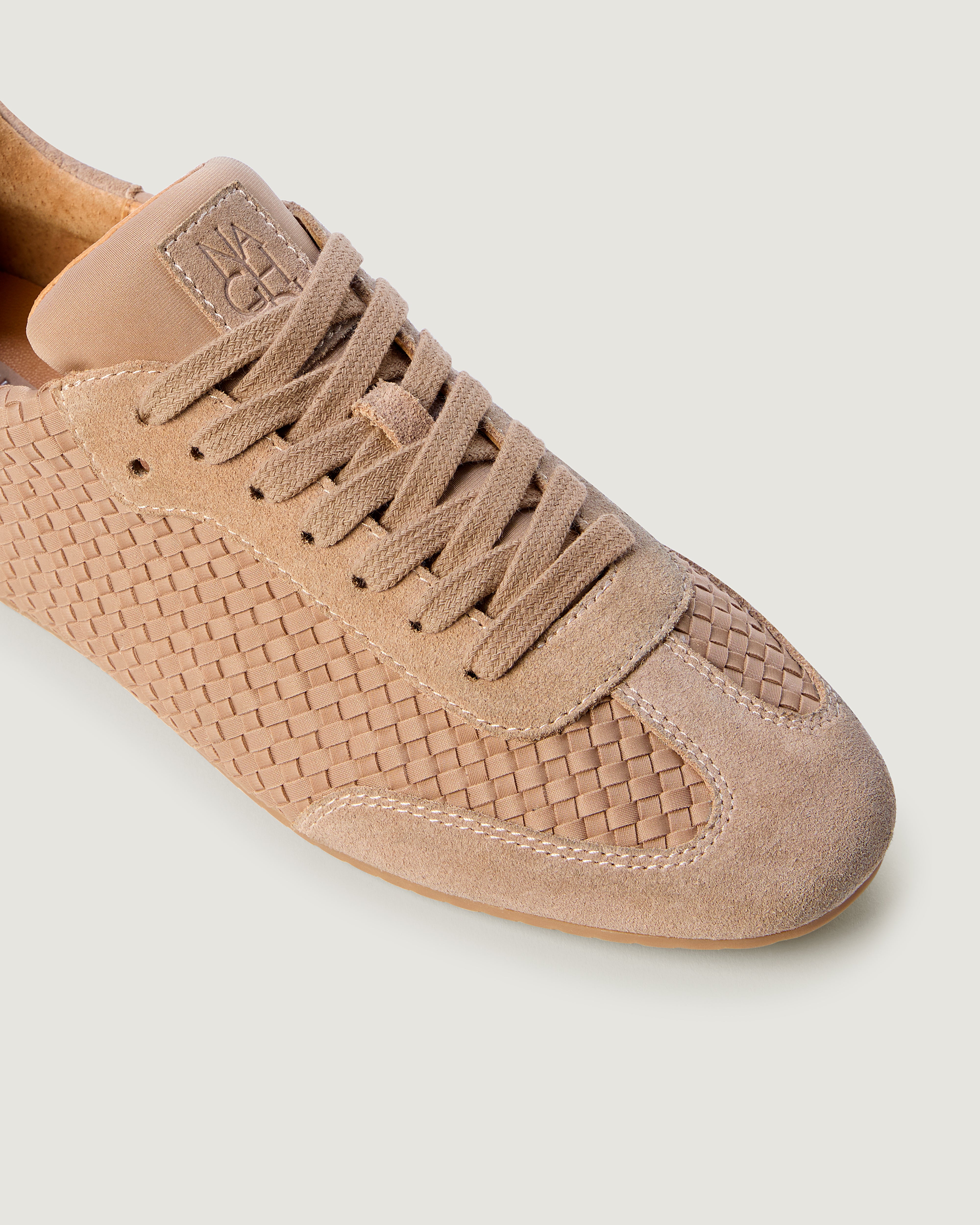 Close-up of The Milan Sneaker in Seychelles showing its tonal suede trim.