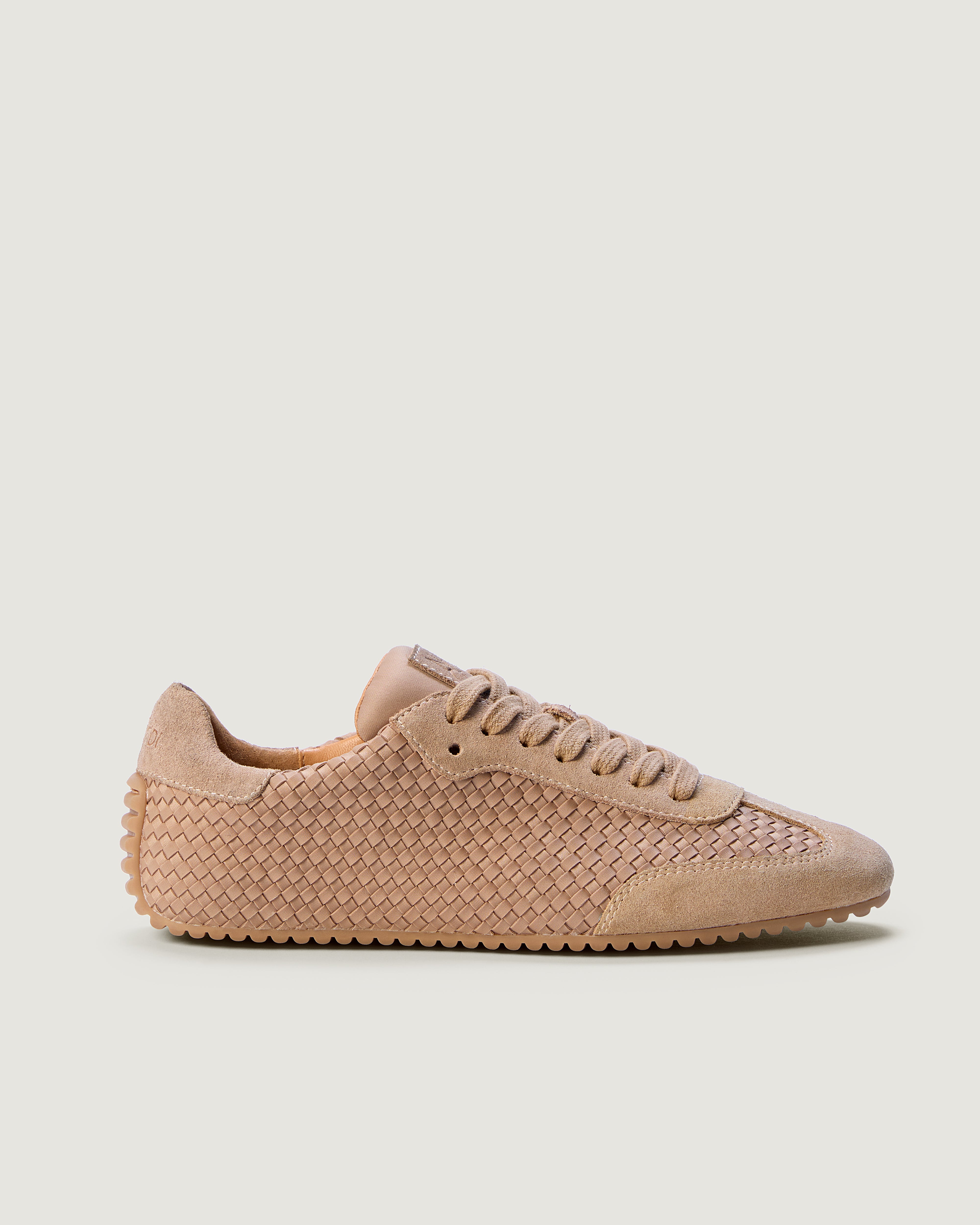 Side view of The Milan Sneaker in Seychelles, a pinkish beige, featuring a closed toe and almond silhouette.