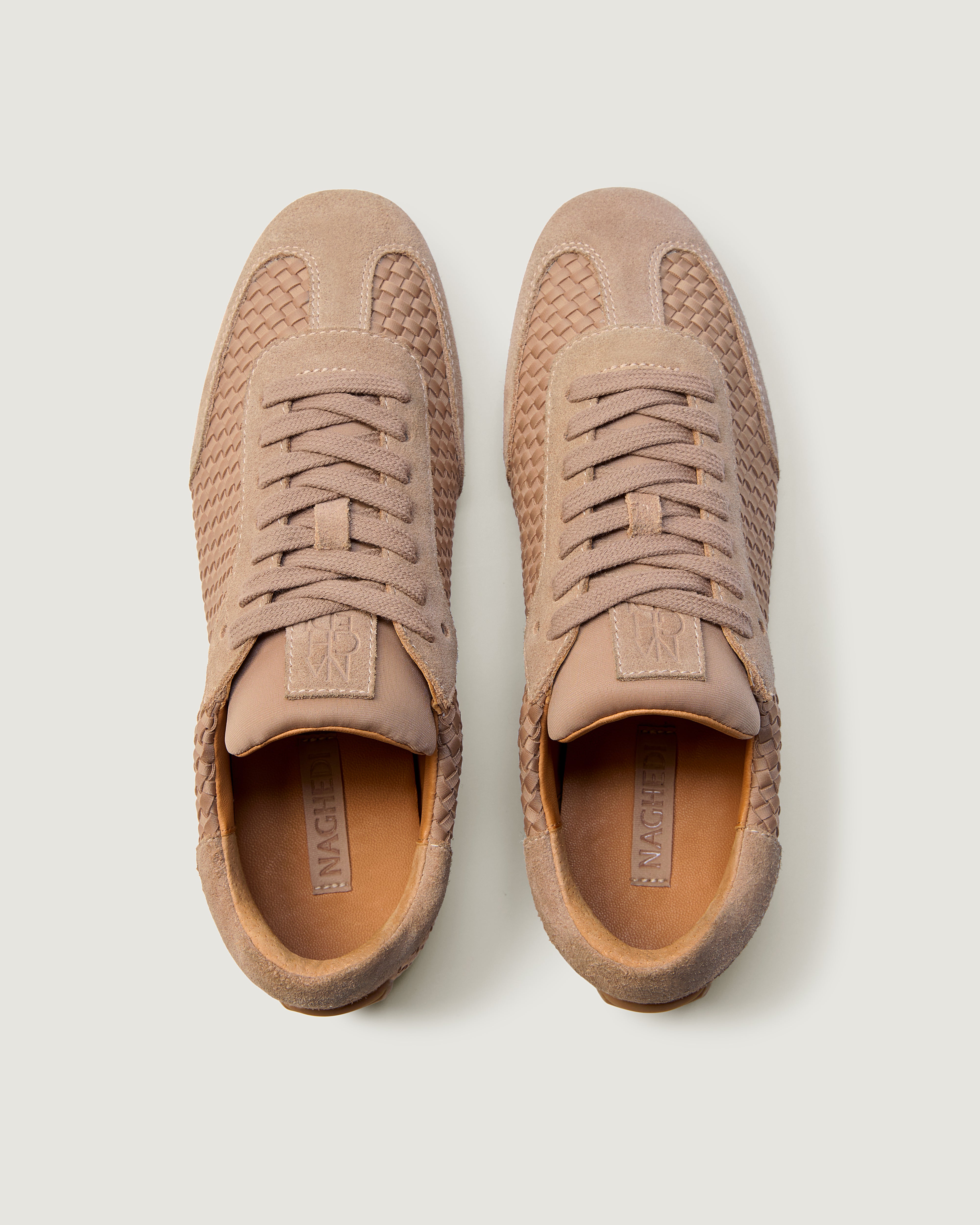Top view of pair of The Milan Sneaker in Seychelles showing the natural tanned leather insole.
